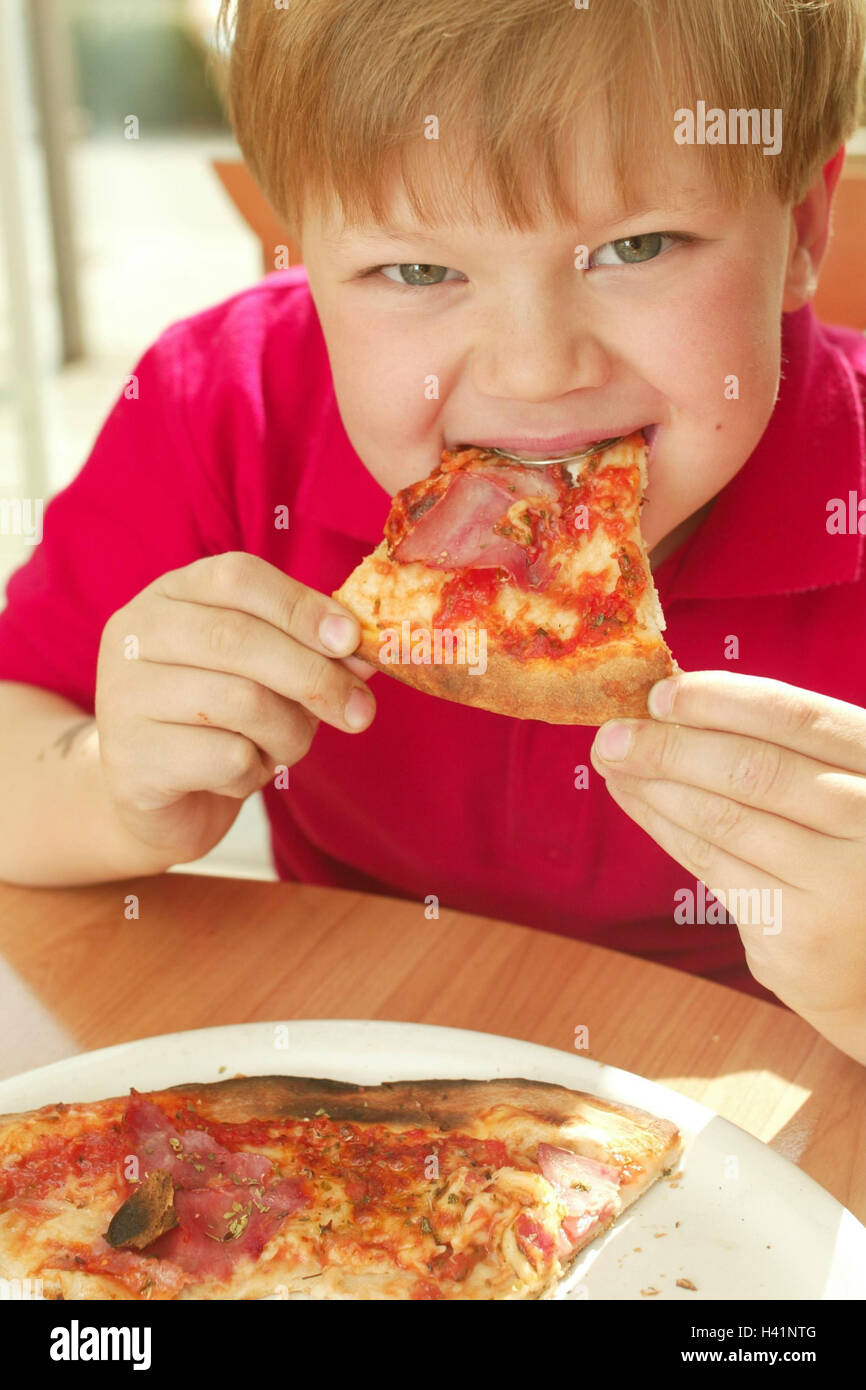 Boy, brace, pizza, eat child, 7 years, hunger, lunch, nutrition, hunger, appetite, intermeal, snack, meal, food, dish, curled Stock Photo