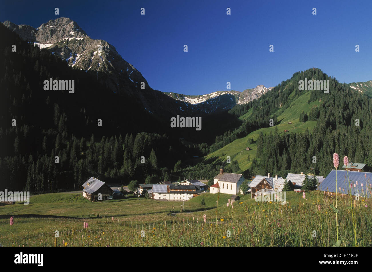 Austria, small Walsertal, Baad, 1244 m, local view, church, Europe, Vorarlberg, Kleinwalsertal, district the parish Mittelberg, village, place, houses, residential houses, mountain landscape, mountains, Aries's stone, 2533 m, summers Stock Photo