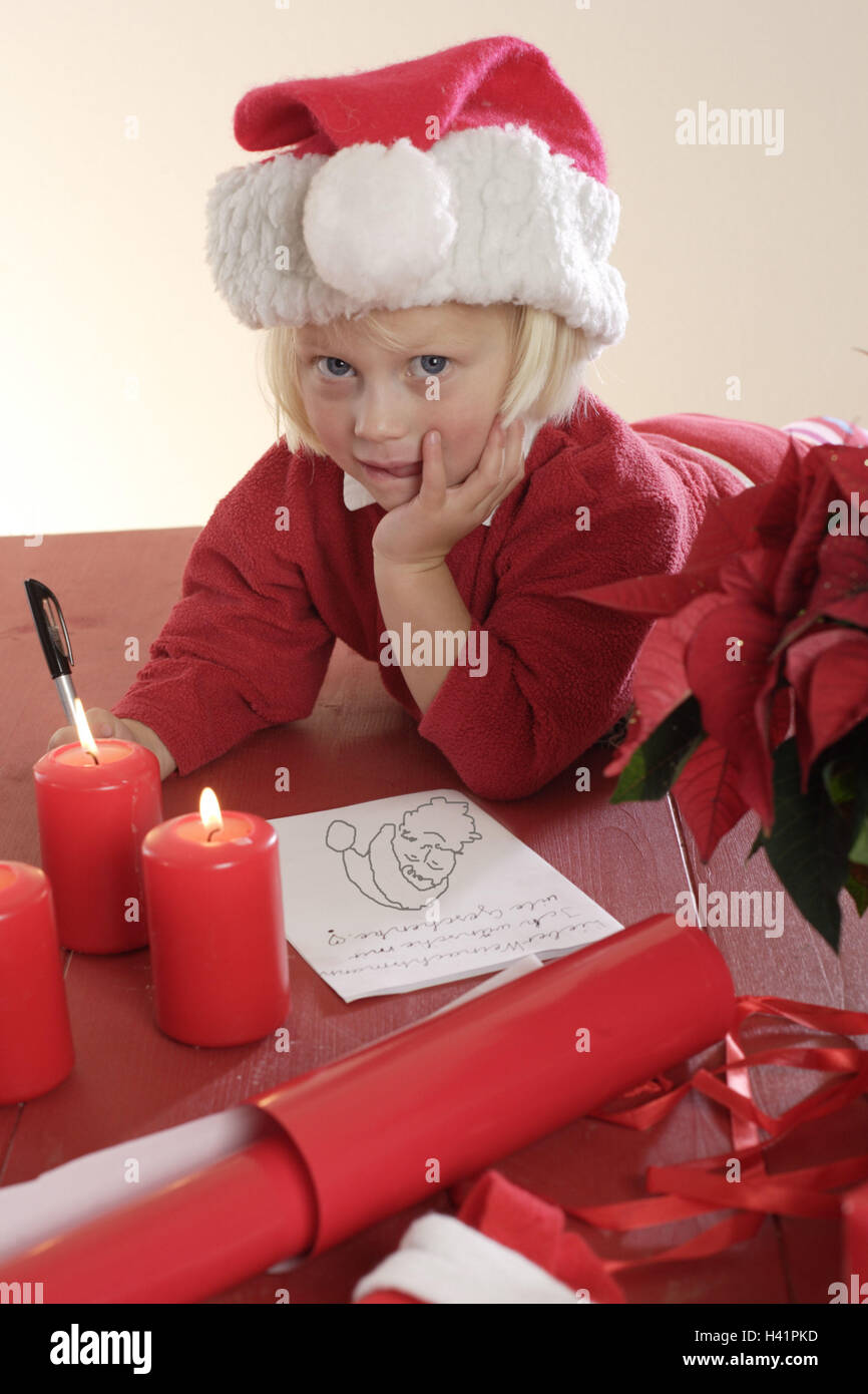 Advent, girls, Nikolausmütze, Table, draws, gaze camera  Advent season, pre-Christmas period, Christmas time,  Child, toddler, 3-5 years, cap, headgear, block, papers, red-white paints, activity, Childhood, freely, flowerpot, poinsettia, Candles, burning, Christmas, christmassy, interior Stock Photo
