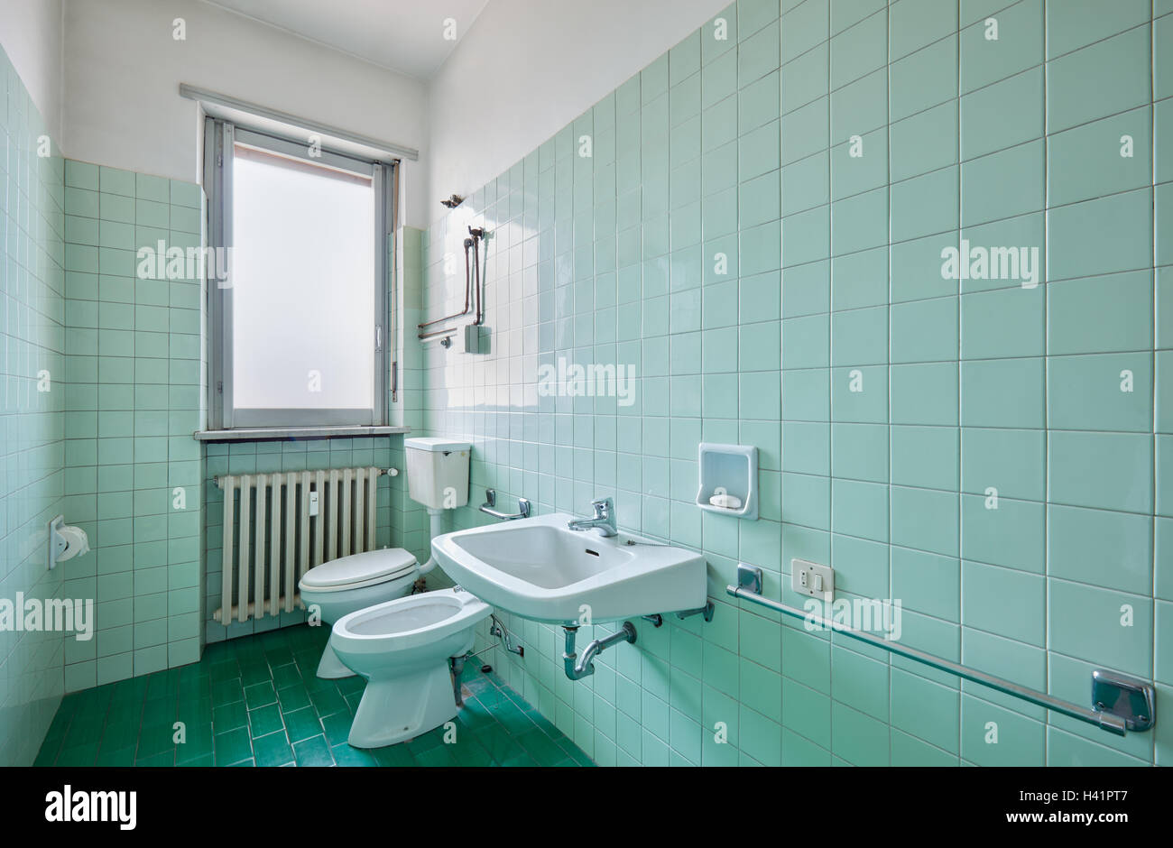 Old bathroom interior with green tiles Stock Photo