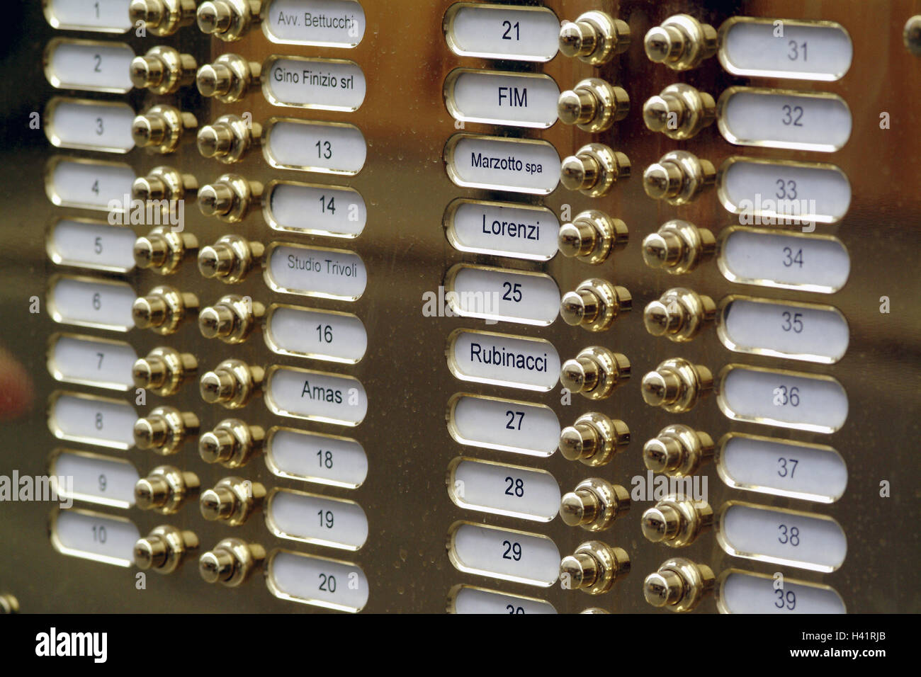 Italy, Milan, block of flats, pinking, detail, Europe, Southern Europe, Repubblica Italiana, region Lombardy, Milano, town, residential house, doorbells, bell signs, names, numbers, inscription, buttons, bell buttons, golden, brass, shine, Still life Stock Photo