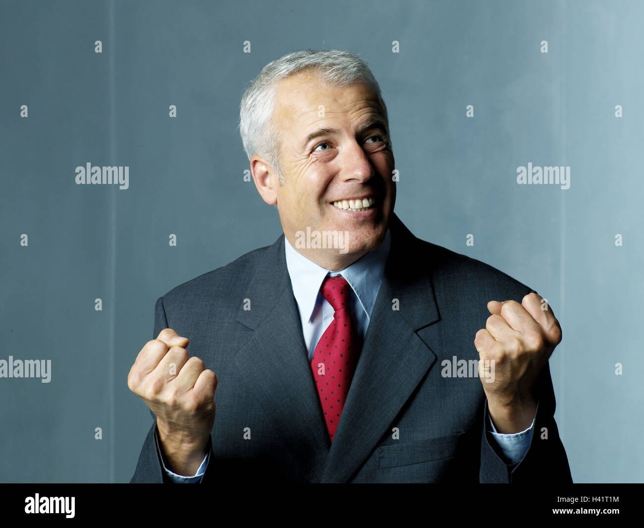 Man, grey-haired, middle old person, suit, enthusiastically, side glance, portrait, businessman, Manager, grey hair, gray hair, cultivated, seriously, smile, look up to high-level views, gesture, fists, emotion, enthusiasm, joy, success, victory, profit, positive mood, happy, contently, pleases, crazily, passionately, emotionally, certainly about victory, confidently, self-confidently, successfully, studio, Stock Photo
