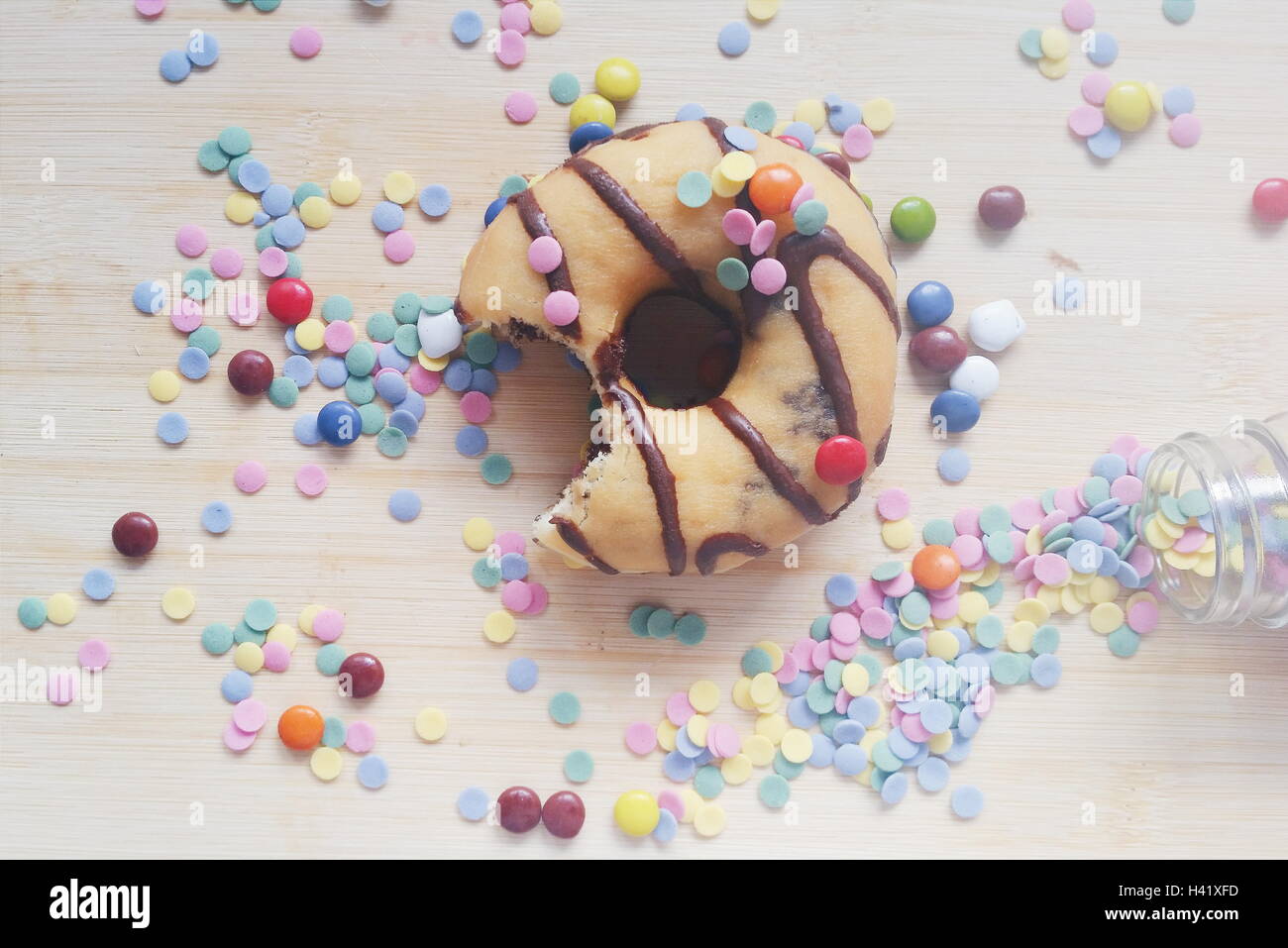 Half eaten doughnut with confetti and candies Stock Photo Alamy