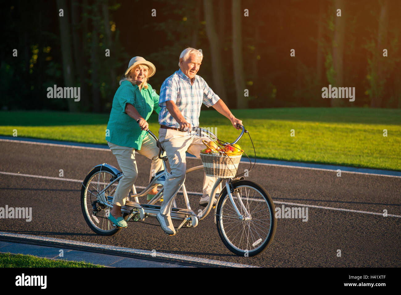 Senior couple rides tandem bike Stock Photo Alamy