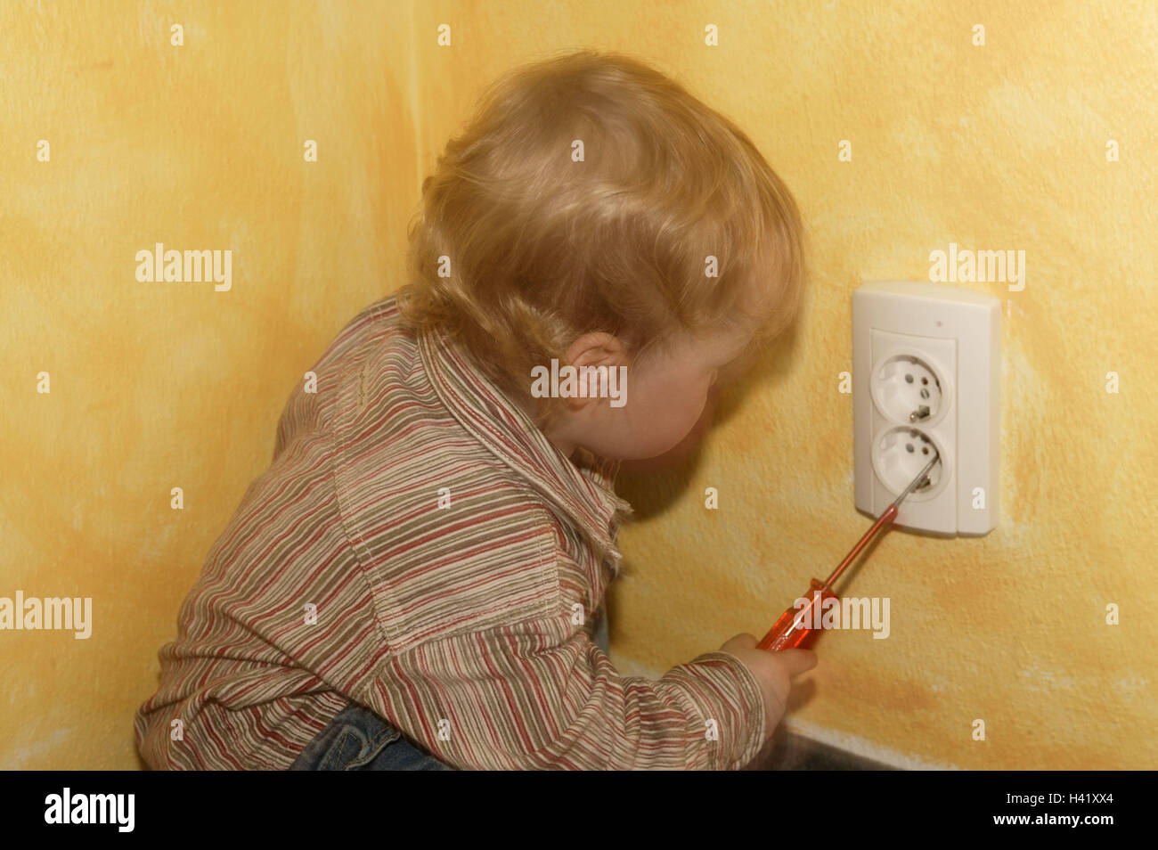 Infant, play, socket, screwdriver, mortal danger danger, accident, danger collision, tools, current, shunt, activity, experiment, electric shock, backup, care, household, obligatory supervision, unattended, child, boy, 1 - 2 years, floor, sit, inside, chi Stock Photo