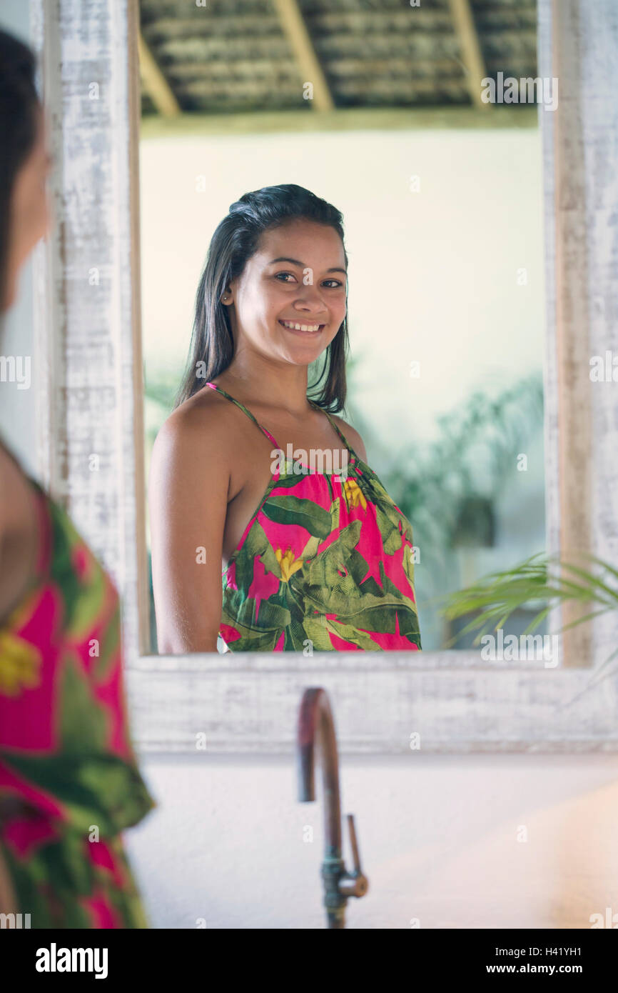 Mixed Race girl smiling in mirror Stock Photo
