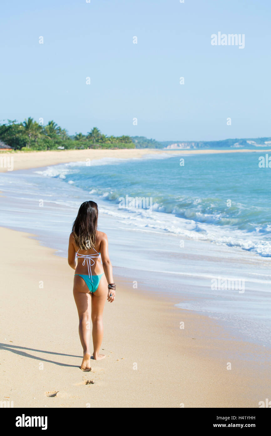 Mixed Race girl walking on beach Stock Photo