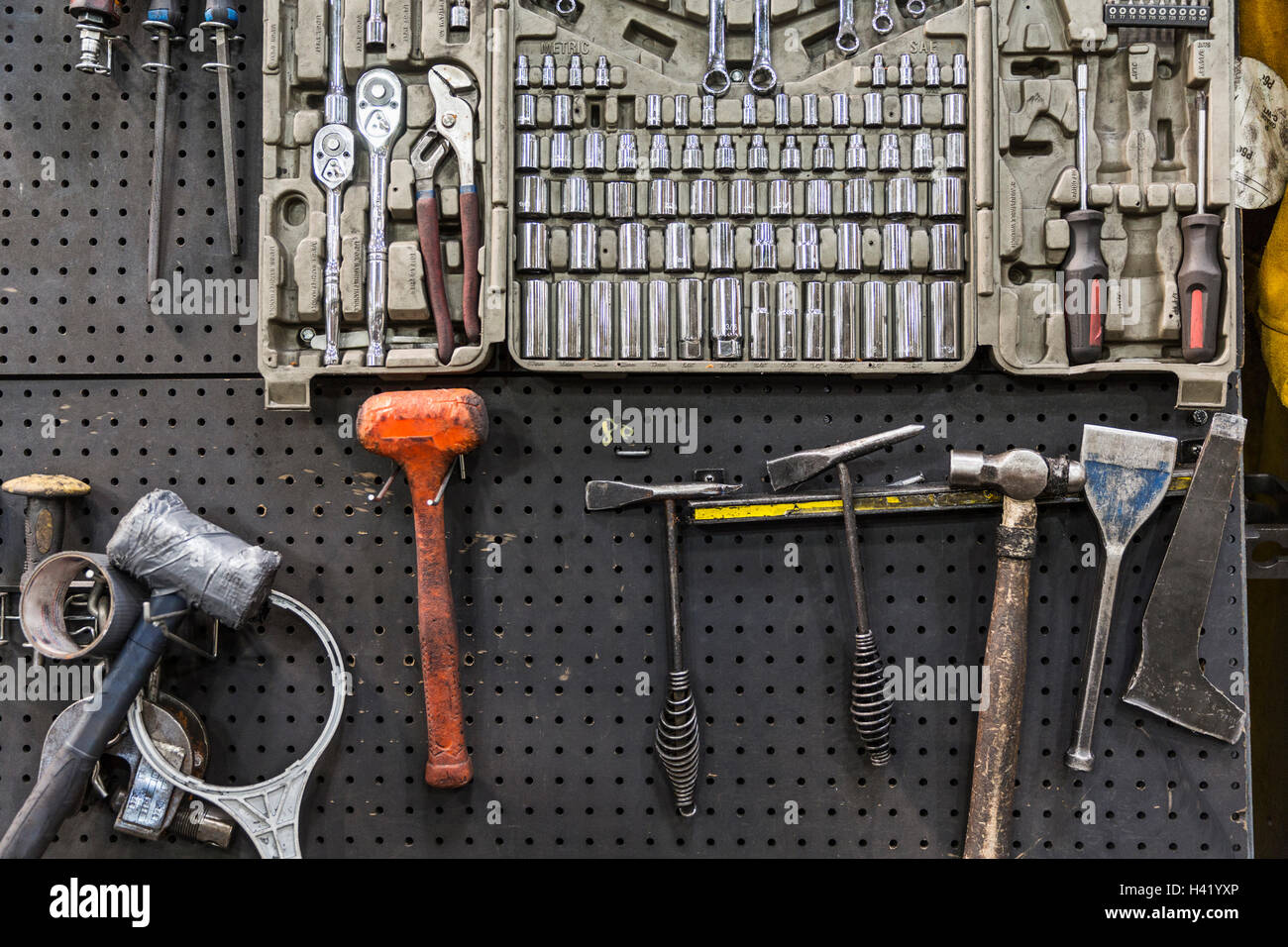 Tools hanging on pegboard Stock Photo