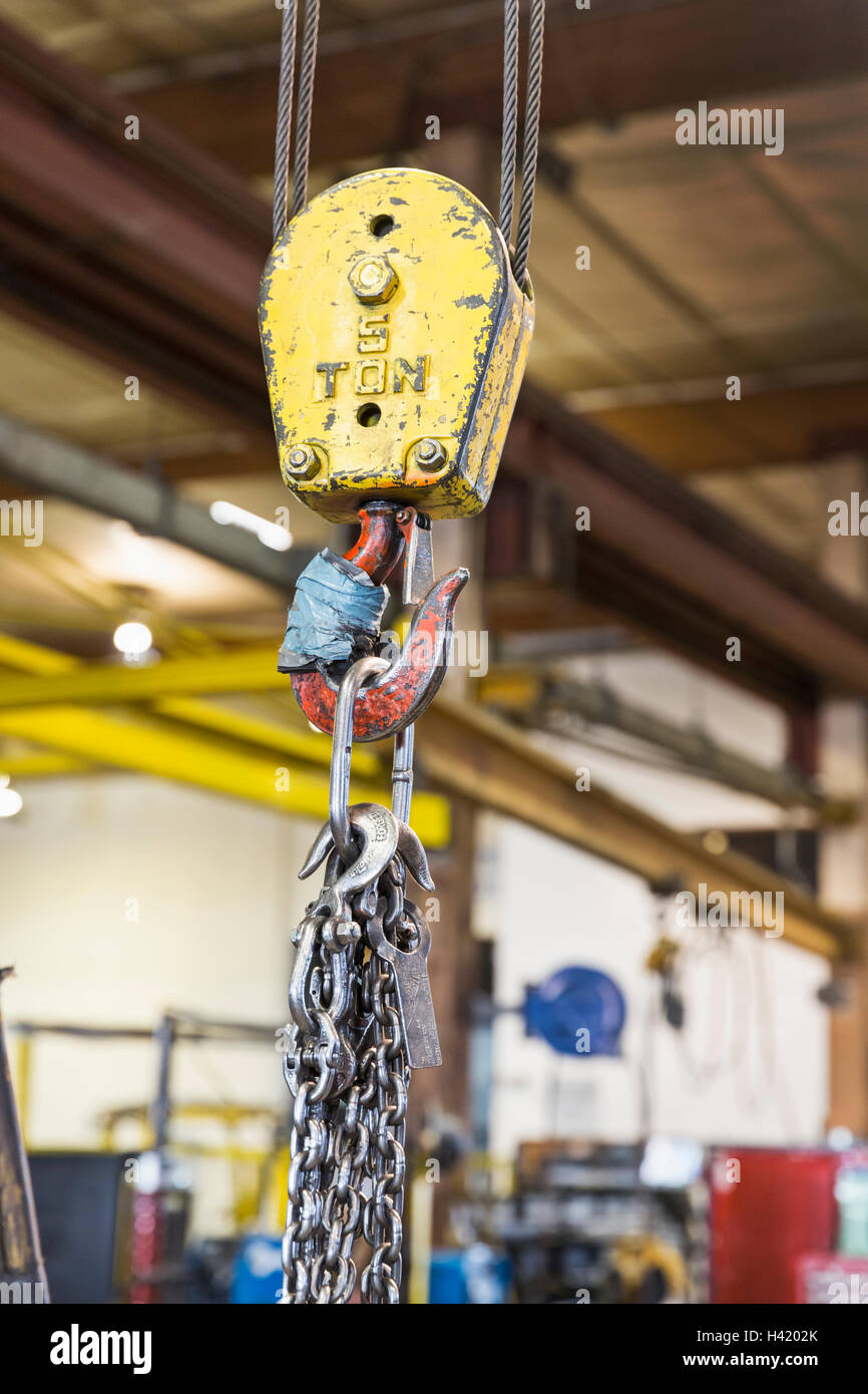 Pulley and chain hanging in factory Stock Photo