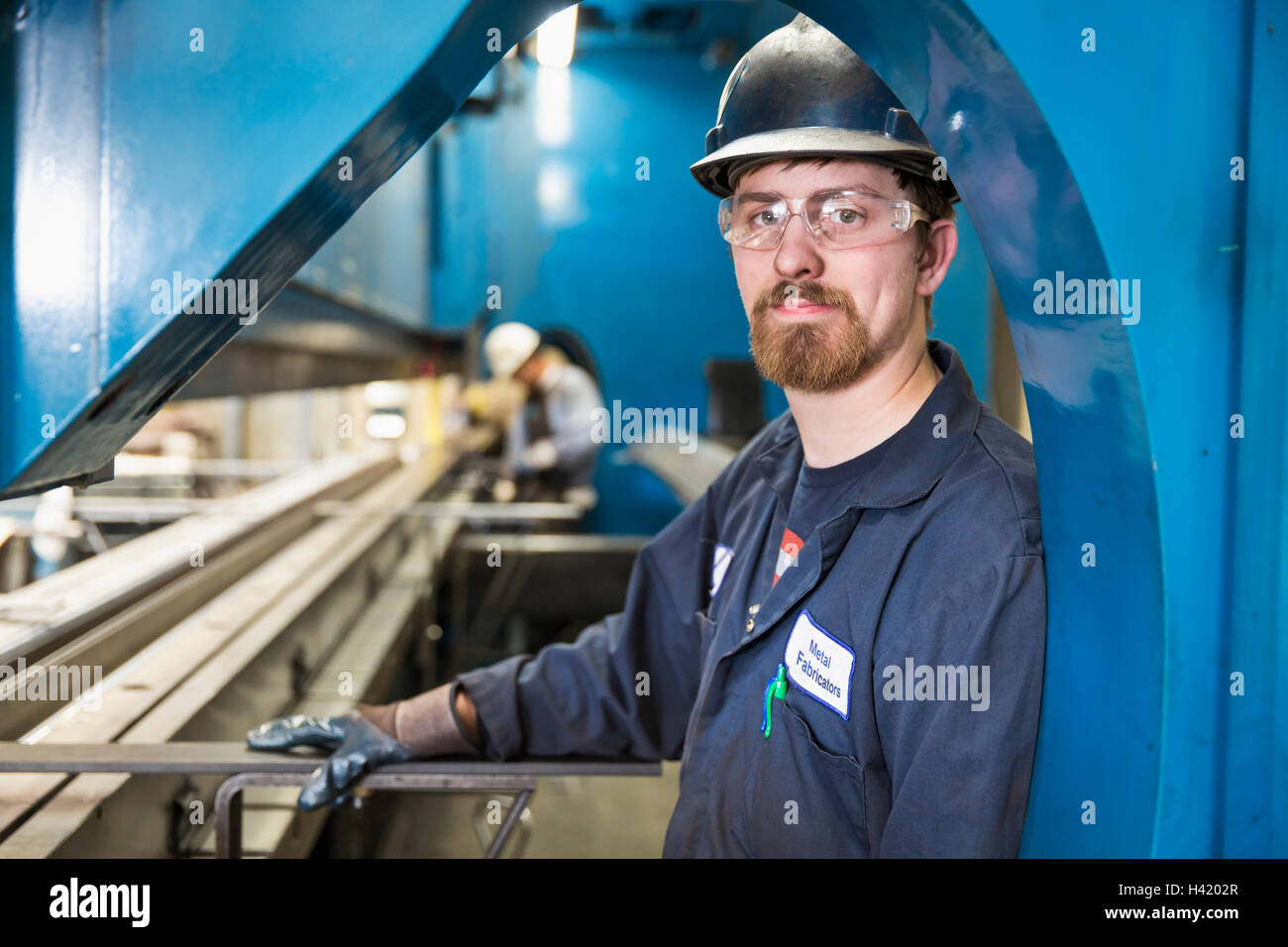 Caucasian worker posing in factory Stock Photo