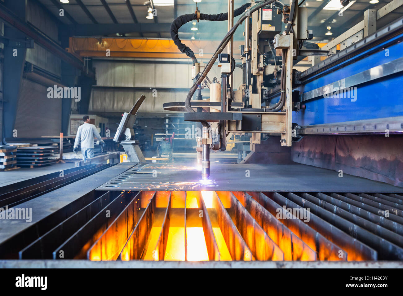 Machinery fabricating metal in factory Stock Photo