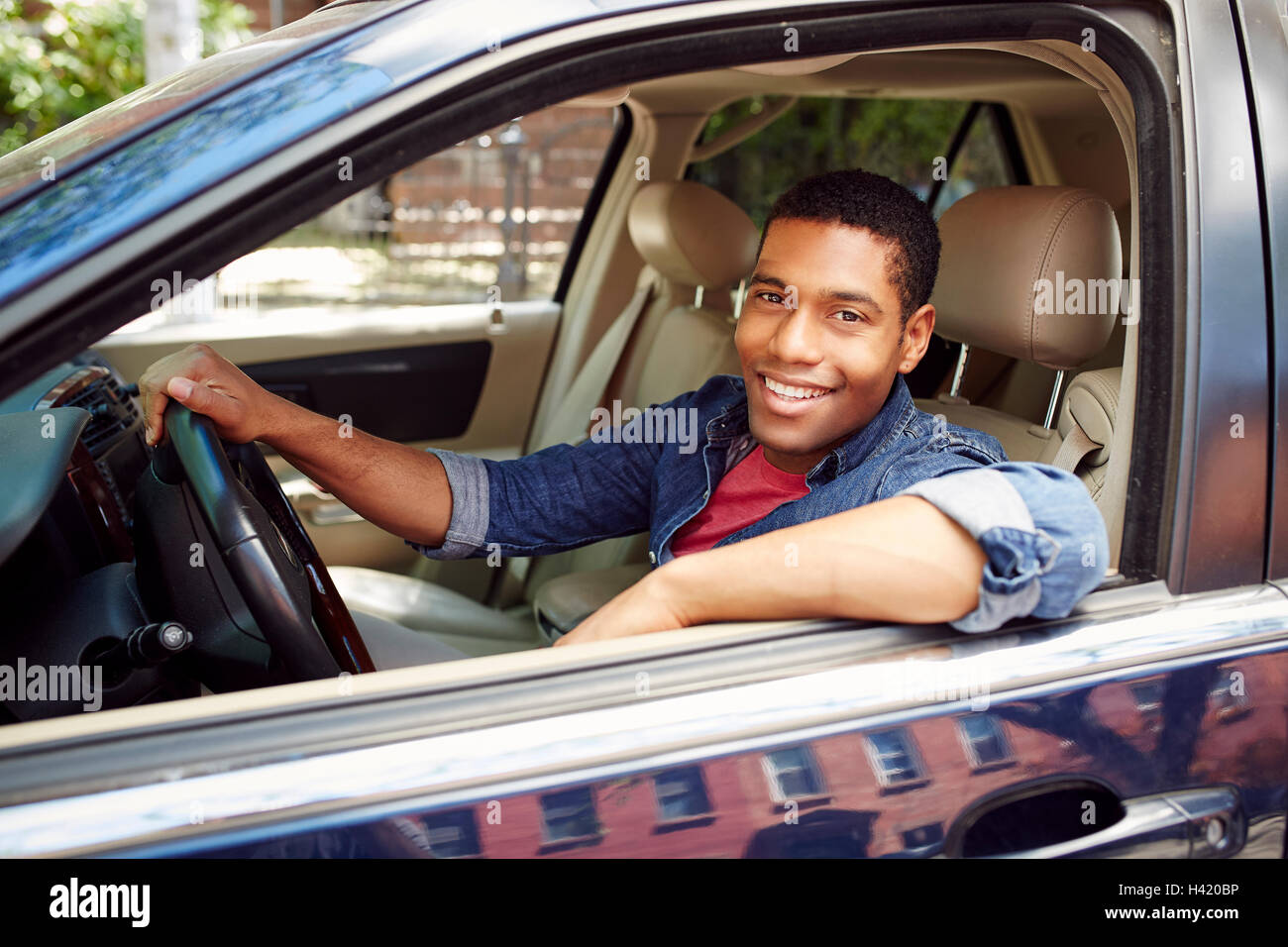 Guy in a shirt with suspenders posing at the retro car 11458874 Stock Photo  at Vecteezy