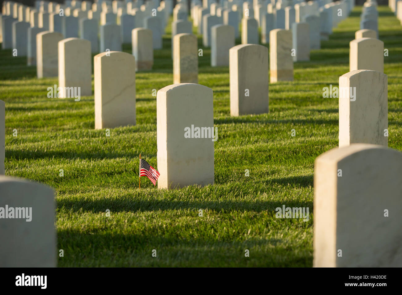 American flag at cemetery gravestone Stock Photo
