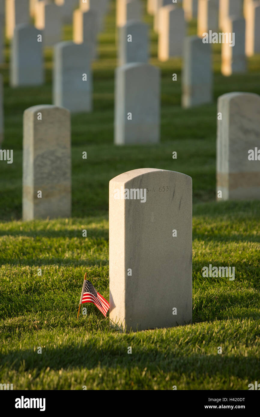 American flag at cemetery gravestone Stock Photo