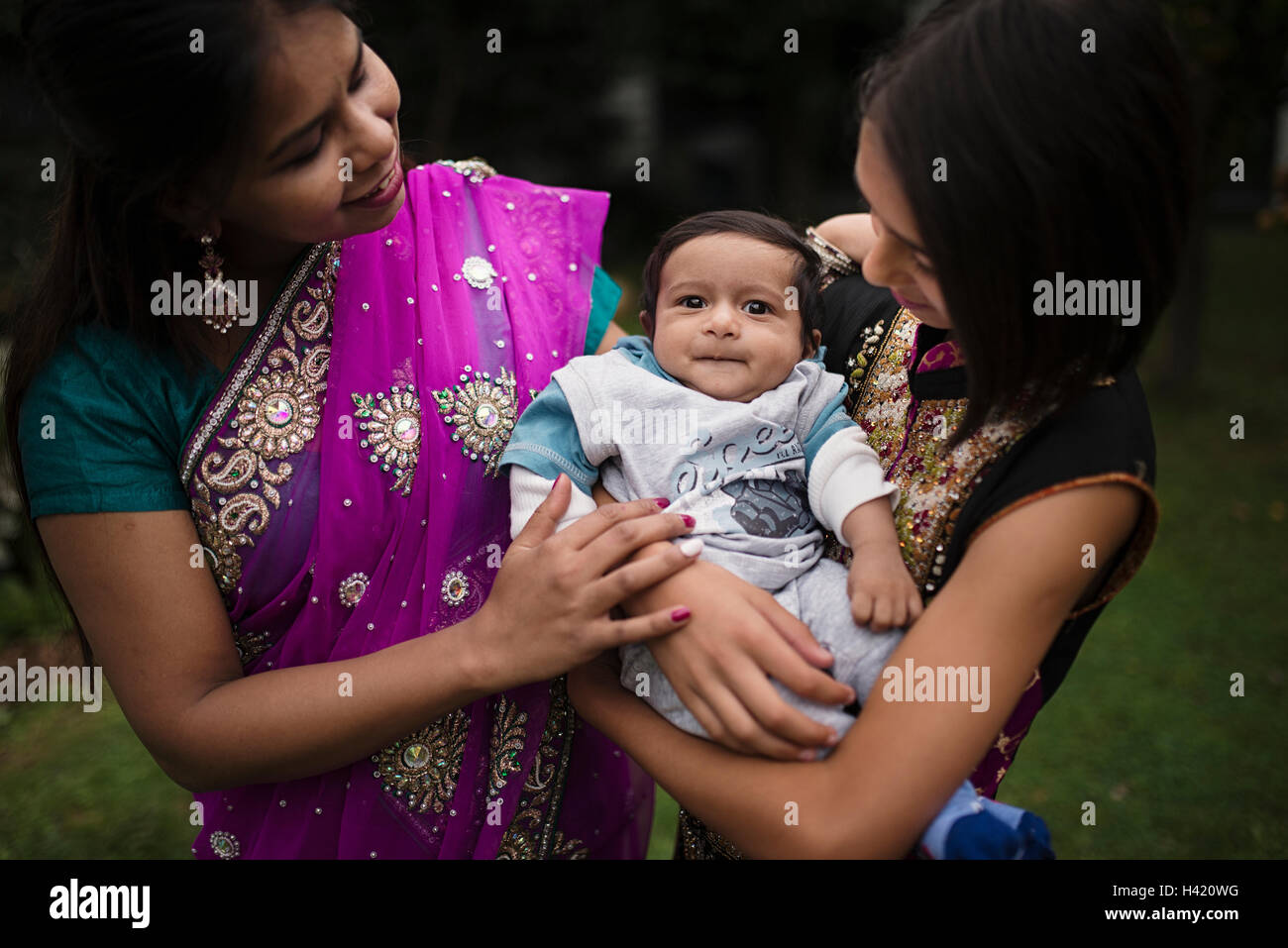 Mother and daughter admiring baby boy Stock Photo
