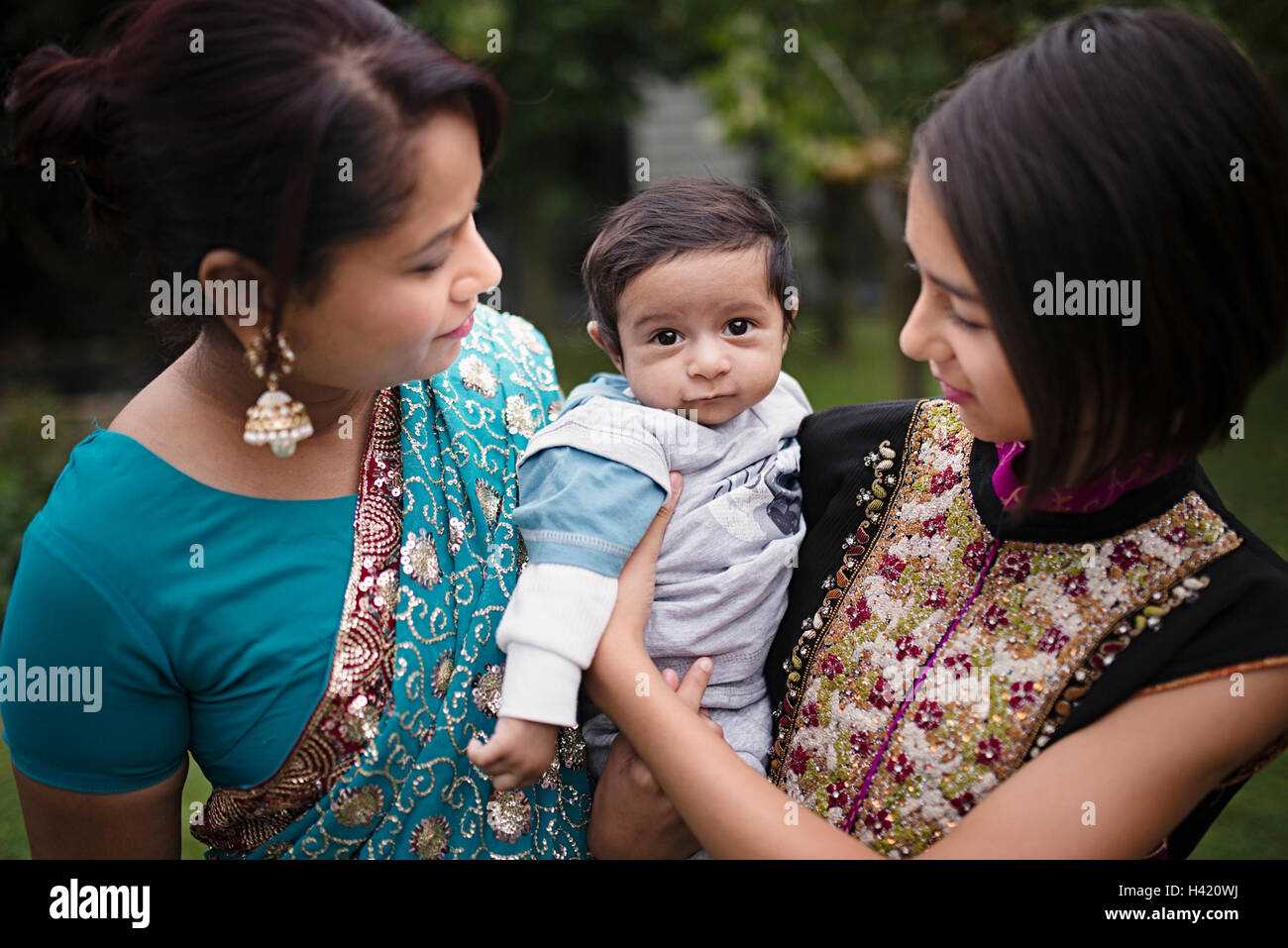 Mother and daughter admiring baby boy Stock Photo