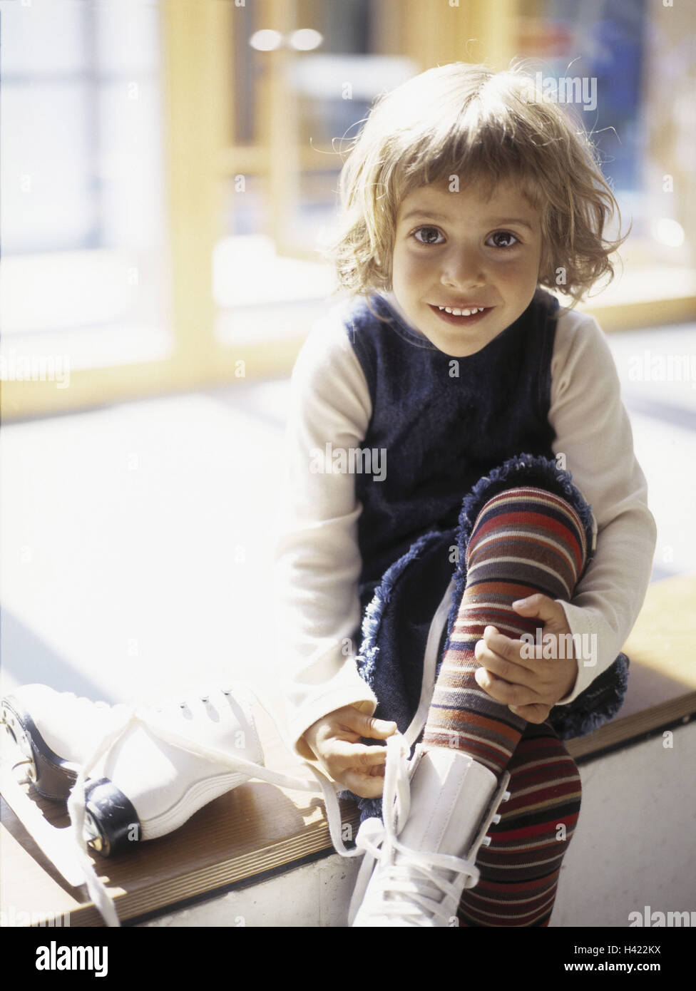 Girls, sit, draw ice skates, child, 5 - 7 years, dress, sock trousers, curled, leisure time, childhood, go skating, ice stadium, shoes, inside, independently, view camera, happy, smile Stock Photo