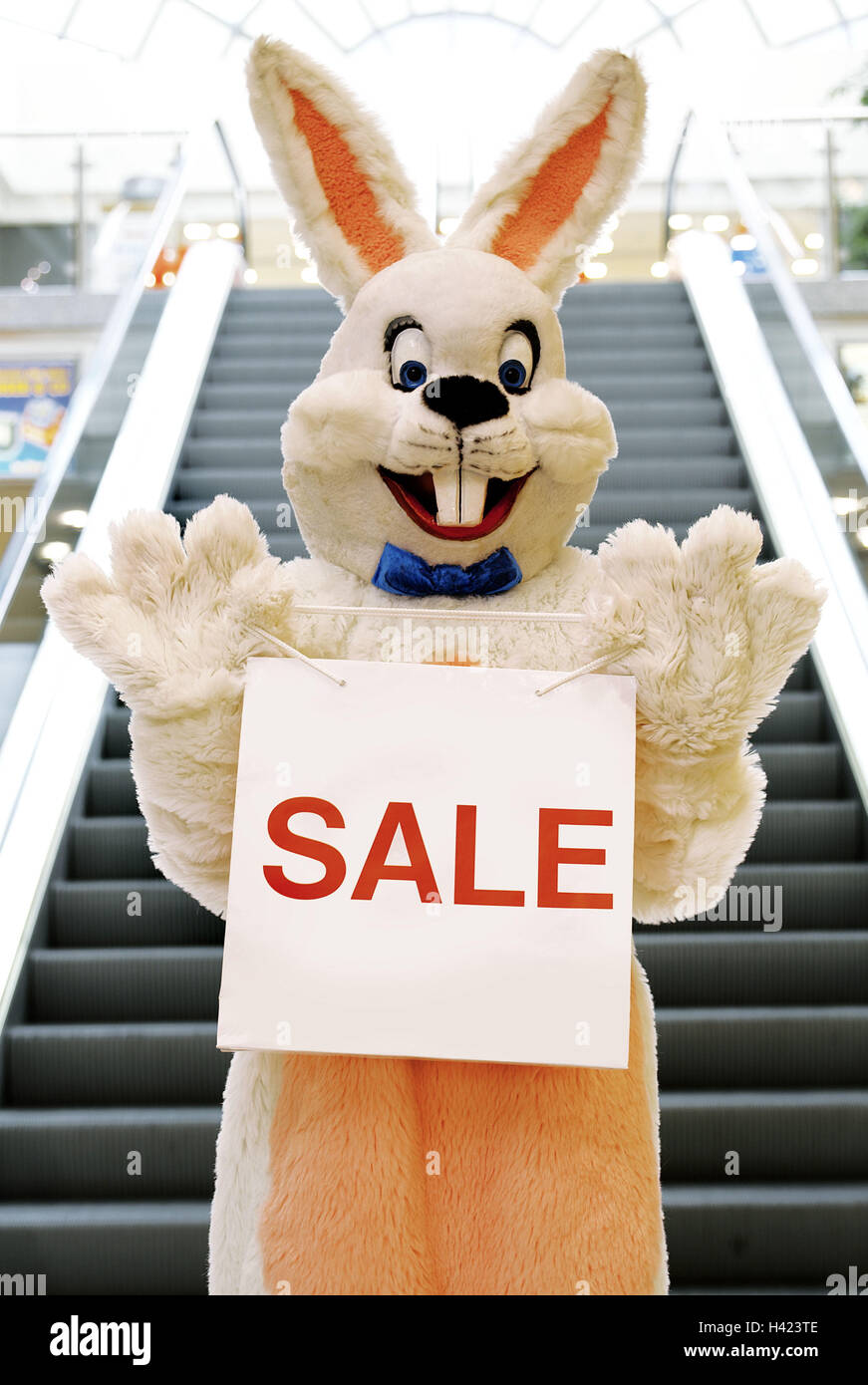 Department store, stairs, Easter bunny, carrier bag, label "SALE" Easter, Easter feast, child's faith, lining, panels, costume, hare's costume, hare, humor, fun, funnily, friendly, happy, joy, inside, purchasing, Easter purchasing, bargain purchase, offer Stock Photo