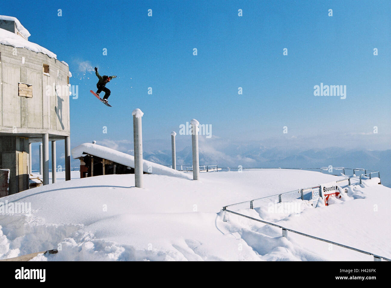 Germany, Lenggries, Brauneck,  Snowboarder, jump, summit house,   Skigebiet, highland shaft, mountain station, buildings, concrete, man, athletes, Snowboarden, Snowboard, snow, winters, in the winter port, jumps, Jump, sport, hobby proficiency skill Fun f Stock Photo