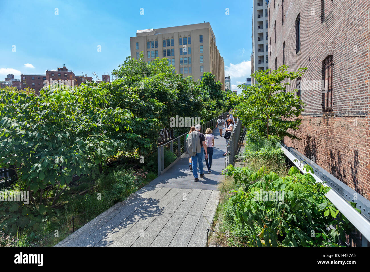 People walking and enjoying The New York City High Line Park. Stock Photo