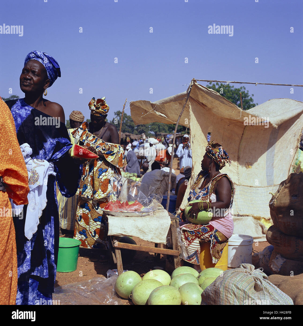 Senegal, Kaolack, market scene, Africa, West Africa, economy, market, market beating out, market stalls, sales booths, women, people, Senegaleses, swarthy, clothes, traditionally, headscarfs, dealer, customers, fruits, fruit, watermelons, melons, trade, s Stock Photo