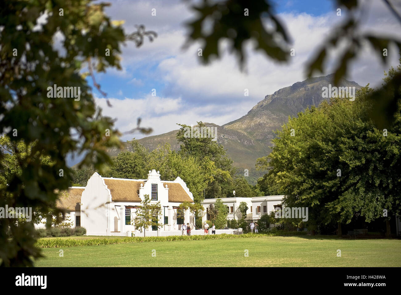 South, Africa, west cape, Stellenbosch, Country lodge, Guest House, park, mountain, cloudy sky, town, town view, building, houses, Victorian, historically, architecture, colonial style, hotel business, boarding house, guest house, guesthouse, accomodation, overnight stay, Winelands, wine-growing area, meadow, trees, outside, people, guests, Africa, Stock Photo