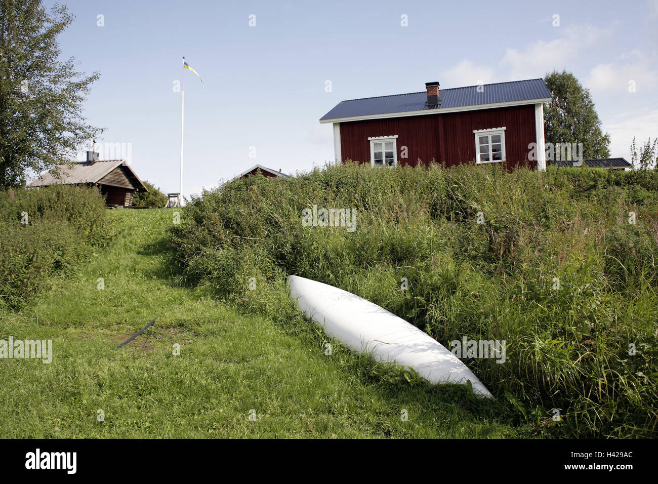 Sweden, Norrland, Norrbotten, timber houses, canoe, Scandinavia, polar circle, meadows, rurally, remotely, shrubs, houses, timber-frame construction way, architecture, typically, typically for country, deserted, neighborhood, red, flag, flagpole, boot, Stock Photo