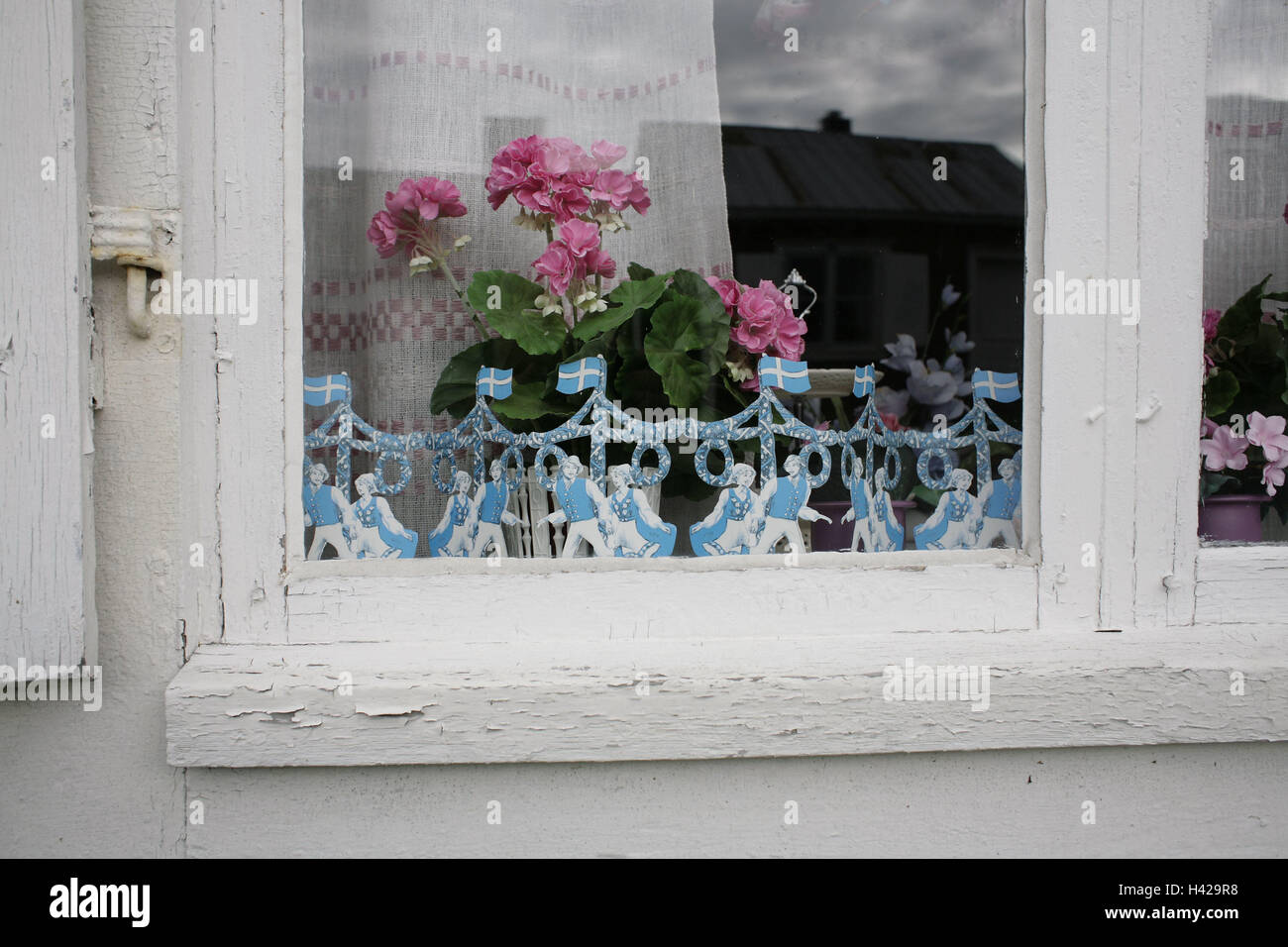 Wooden house, window, detail, decoration, in Swedish, geraniums, pink, Sweden, Norrland, Norrbotten, Lulea, Gammelstad, house, residential house, window pane, flowers, garland, national flags, Mittsommer, Stock Photo