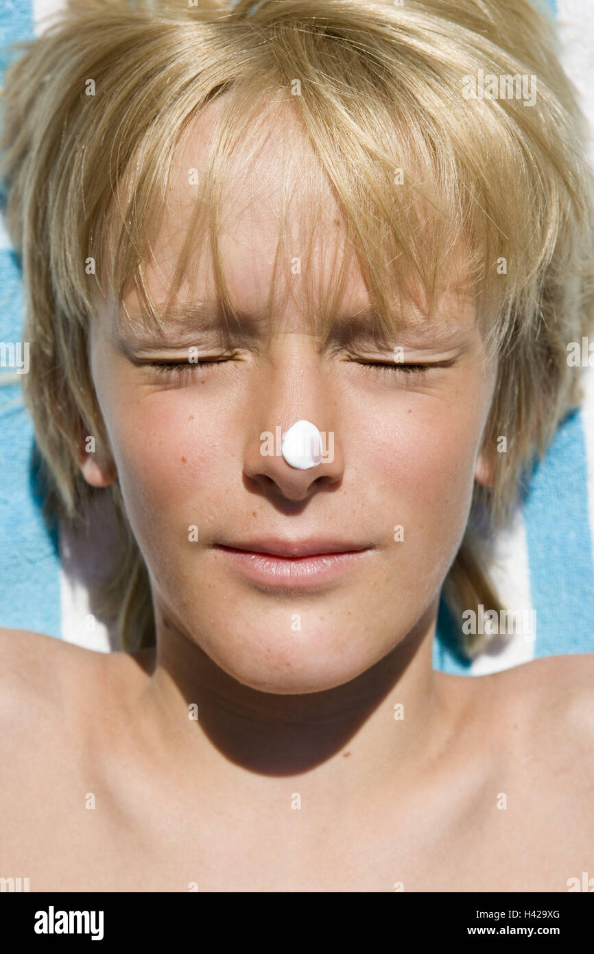 Boy, eyes closed, tip of the nose, sun screen, portrait Stock Photo