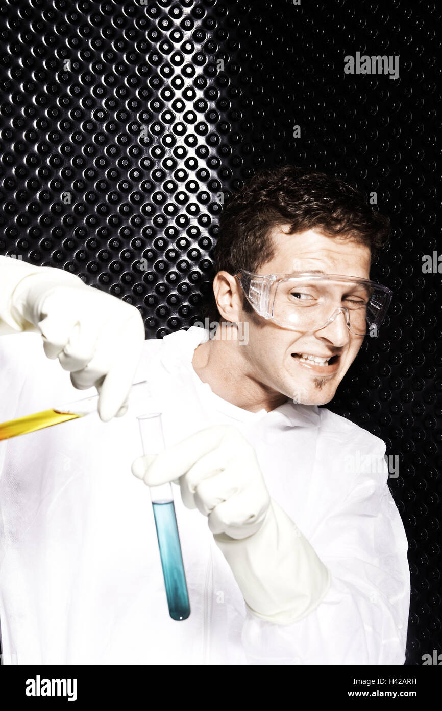 Researchers, protective clothing, safety glasses, test tubes, holding, mixing, people, man, protective clothing, development, research, space, wall, pattern, structure, studs, science, scientist, experiment, liquid, yellow, blue, reaction, dangerous, caut Stock Photo