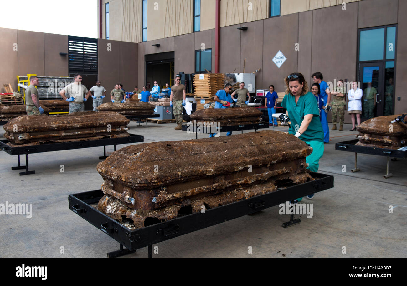 DPAA forensic anthropologists prepare to open the caskets of unidentified U.S. soldiers recently removed from the National Memorial Cemetery of the Pacific at the Defense POW/MIA Accounting Agency Forensic Identification Laboratory October 3, 2016 in Oahu, Hawaii. The remains will then be analyzed in their laboratory for identification. Stock Photo