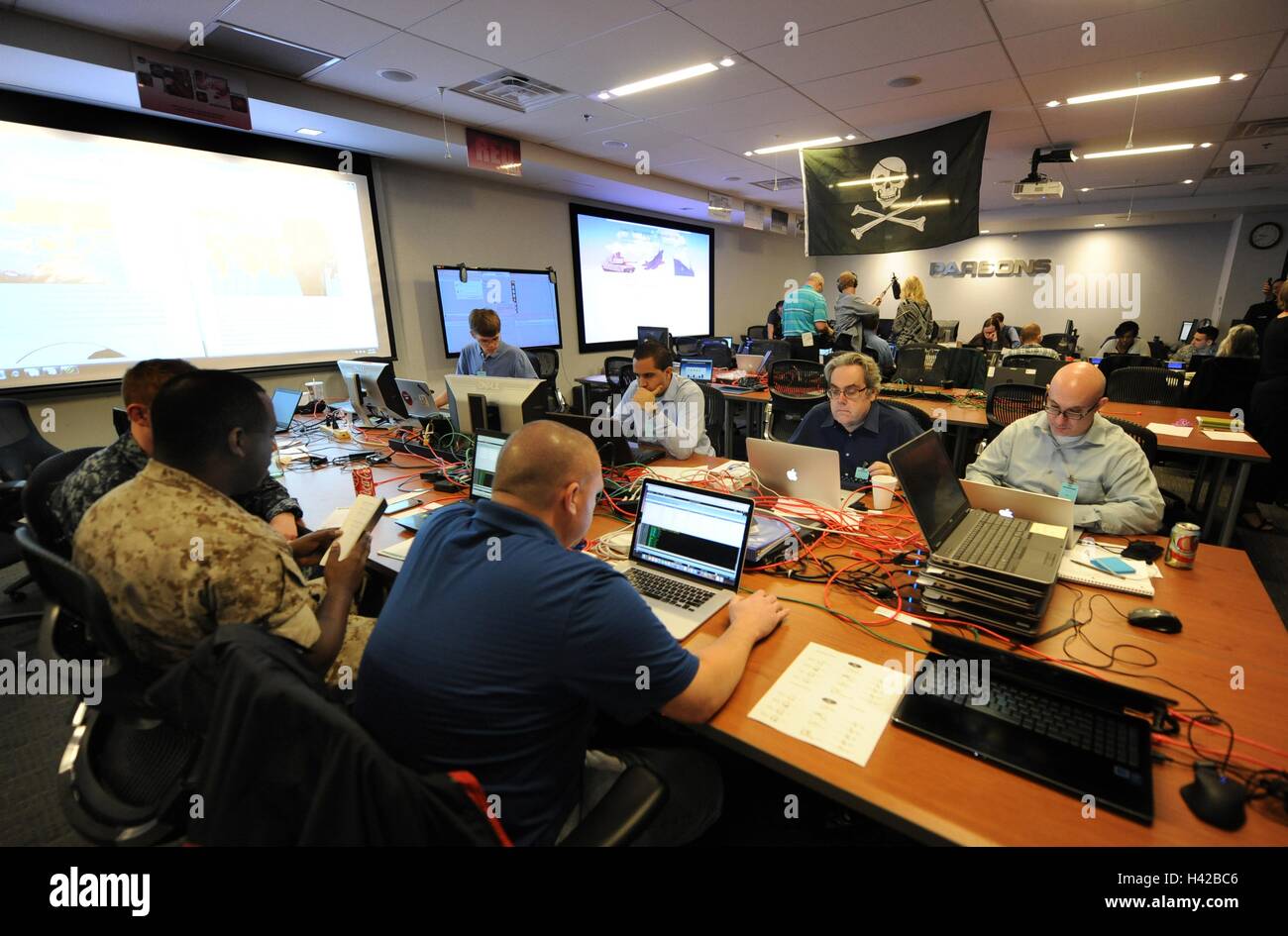National Security Agency employees work on the Cyber Defense Exercise Red Cell computer security operations competition at the Parsons Building May 3, 2016 in Columbia, Maryland. Stock Photo