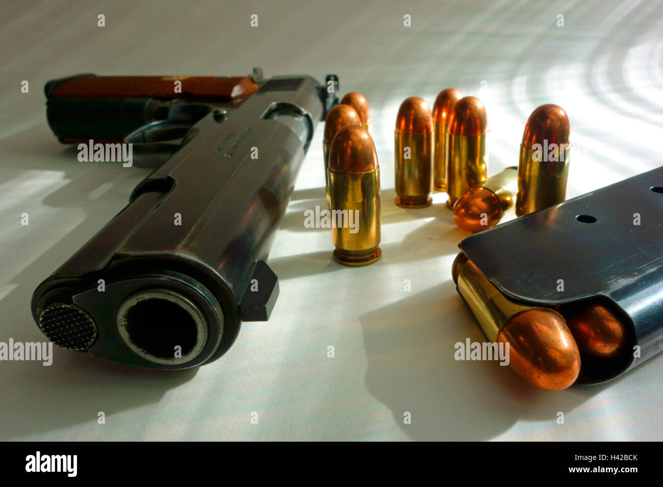 A Colt .45 ACP auto automatic pistol model 1911 and bullets Stock Photo