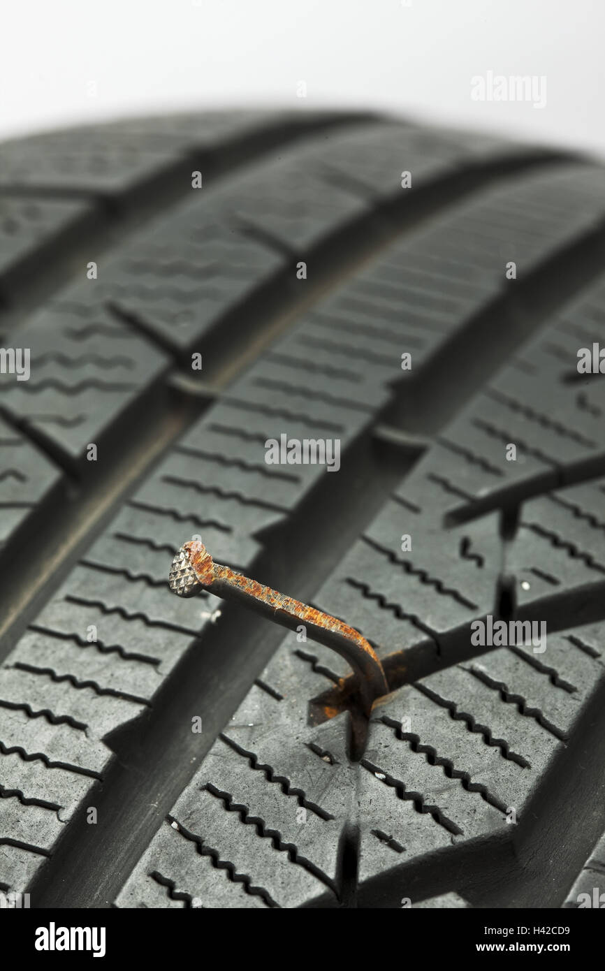 Nail in the automobile tyre Stock Photo - Alamy