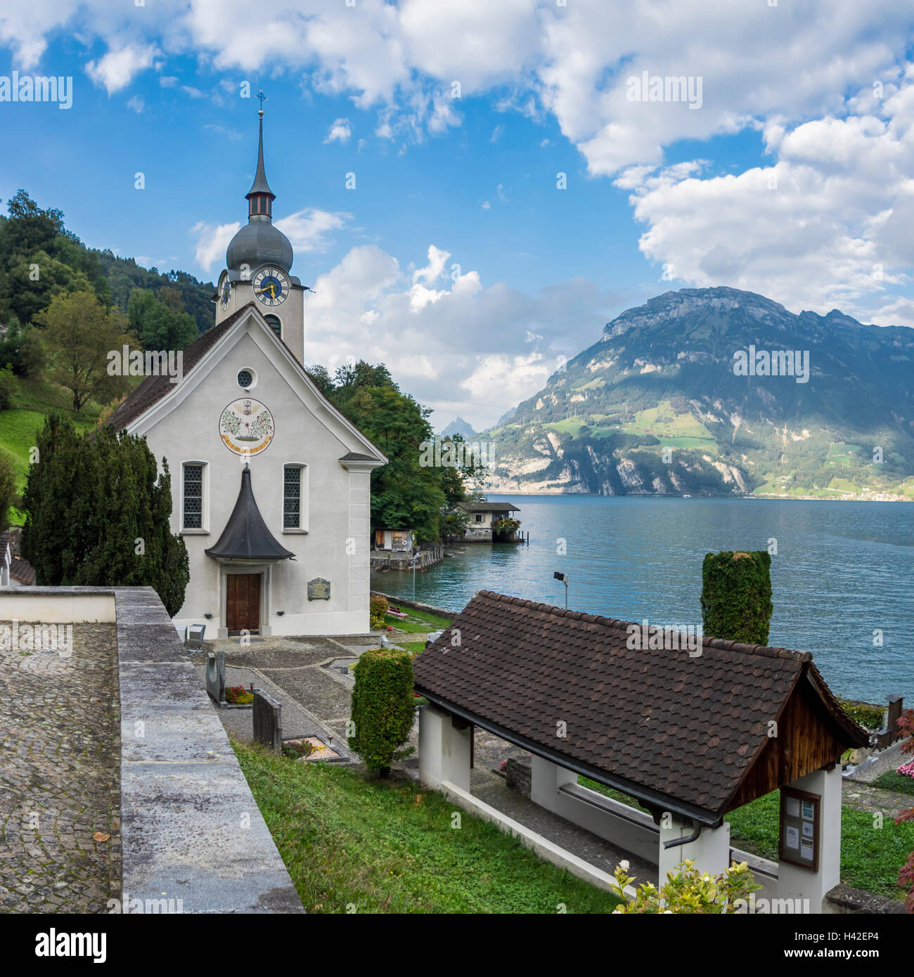 Panoramic view of the church of Bauen, a small village in central Switzerland on the shore of Lake Lucerne (Vierwaldstättersee). Stock Photo