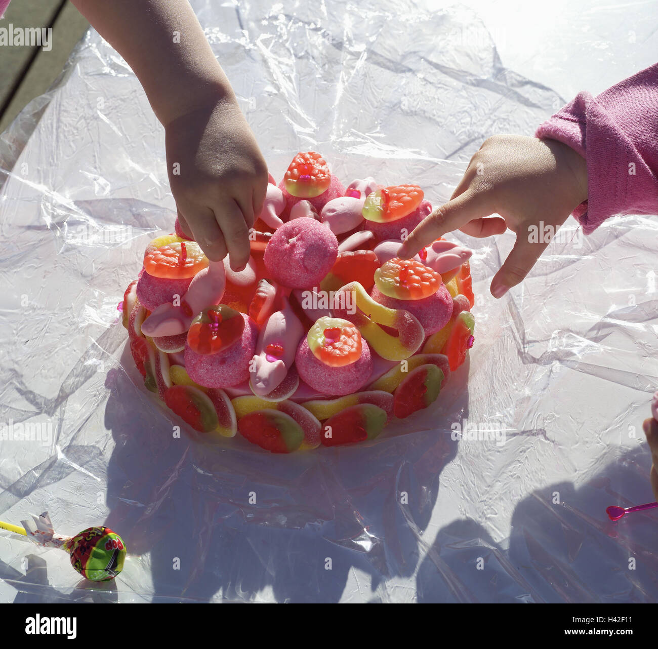 To sweet injustice, child hands, children, detail, hands, curiosity, nibble, cake, sweets, fruit rubber, sweet, sweetly, containing sugar, rich in calorie, calories, nutrition unhealthily, children's birthday party, birthday party, product photography, re Stock Photo