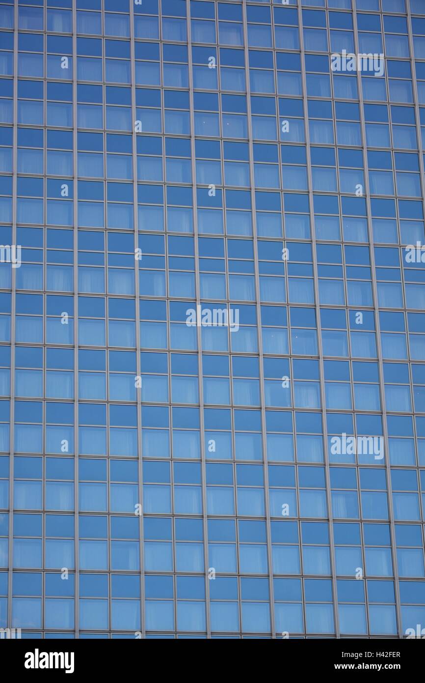 Detail of glass facade of modern office building with reflection of ...