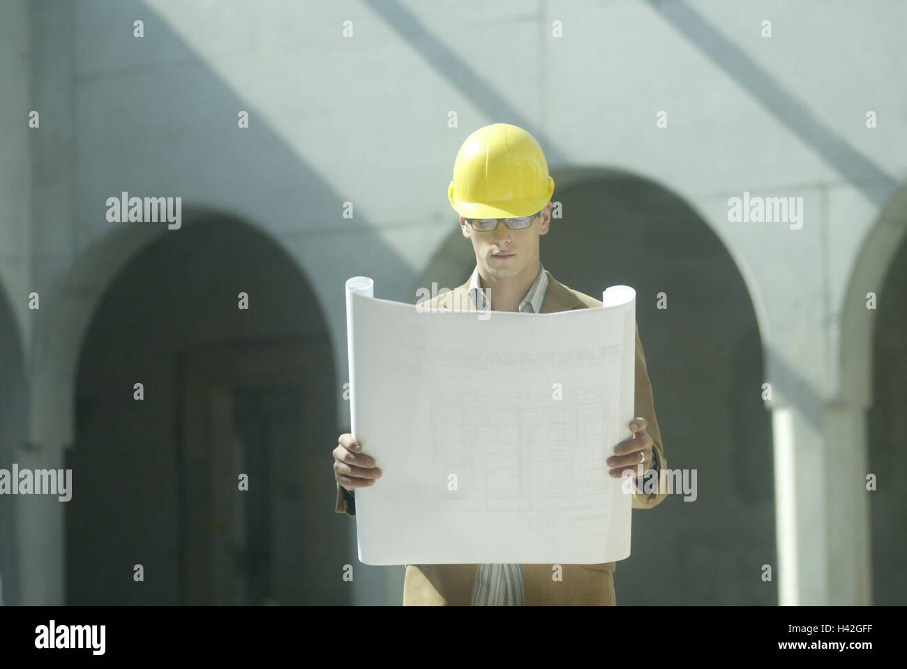 Men at work, architect, construction helmet, plan, control, construction, building of a house, man, 20-30 years, occupation, work, structural engineer, developer, safety helmet, architect's plan, site manager, construction supervision, construction supervision, monitoring, coordination, concentration, attention, curled, building industry Stock Photo