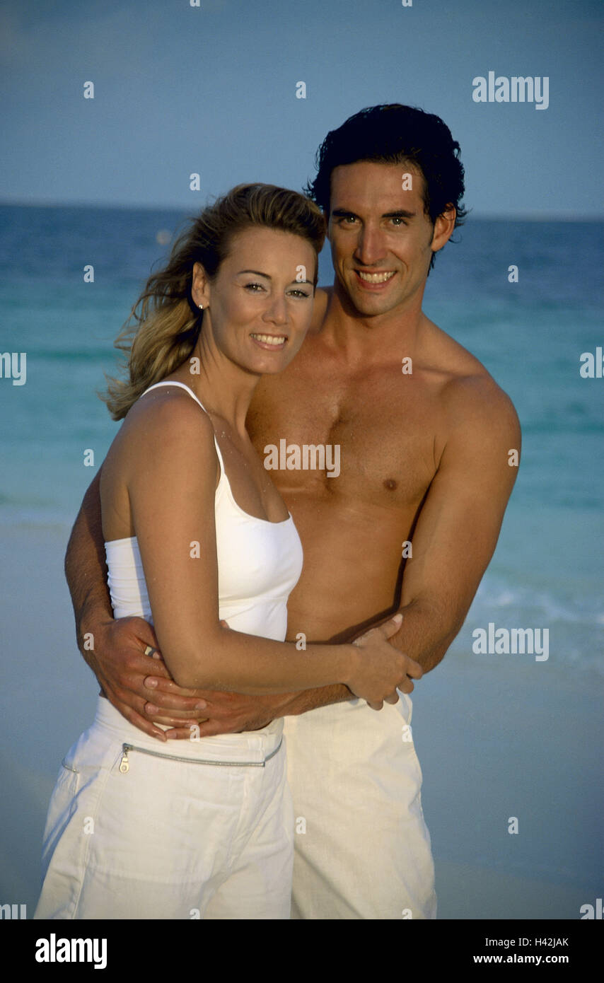Couple, young, smile, embrace, sea, view camera, half portrait, model released, people, man, woman, outside, people, two, falls in love, love, vacation, recreation, happy, browned, with each other, rest, dark-haired, lifestyle, dream vacation, romantically, evening sun, contently, equalised, carefree, attractively, Stock Photo