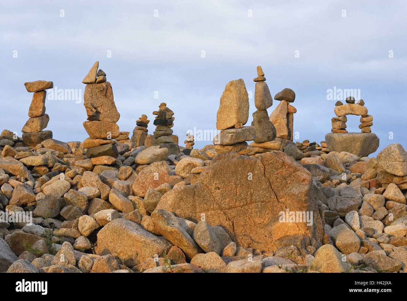 France, Brittany, coast, boulders, cairns, stacked, evening light Stock