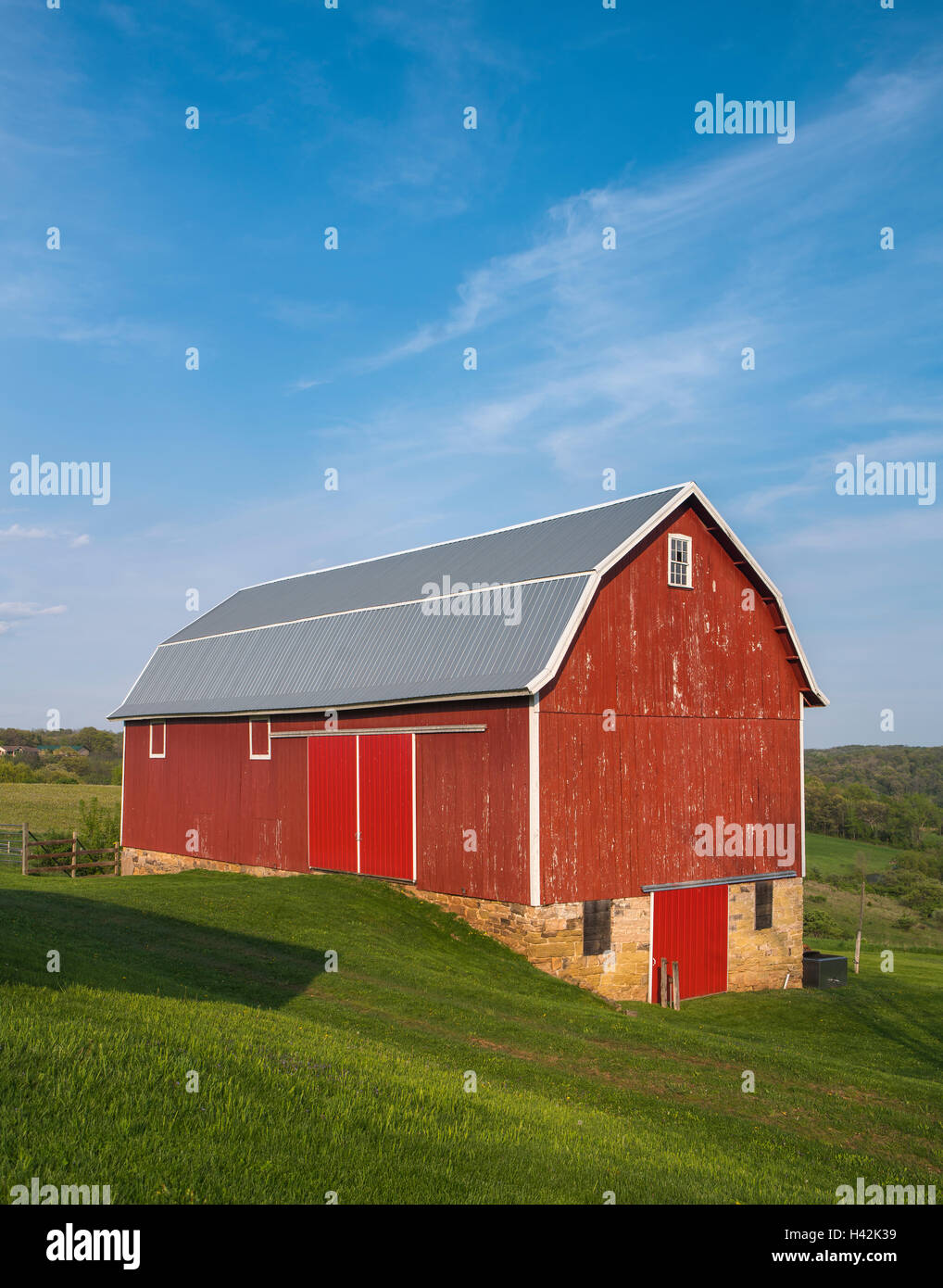 Iowa County, Wisconsin: Red barn, rolling hills under blue sky Stock Photo