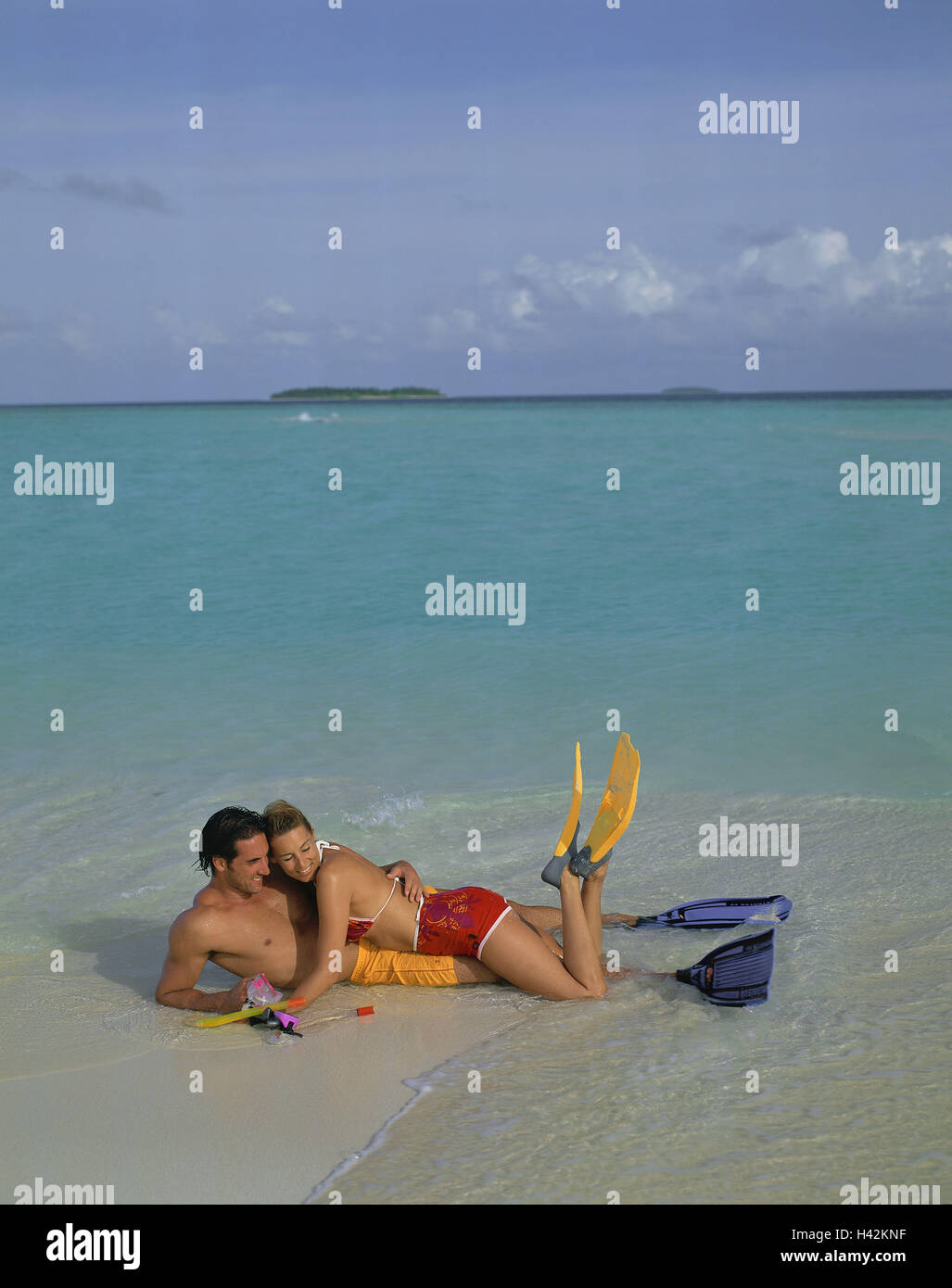 Beach, couple, young, sea, lie, swimming fins, model released, man, woman, person, vacation, sunny, two, people, fun, sportily, lifestyle, together, with each other, falls in love, amuses bath pass, summer, dream vacation, sandy beach, holidays, leisure time, smile, water, on each other, to swimming glasses, fins, Stock Photo