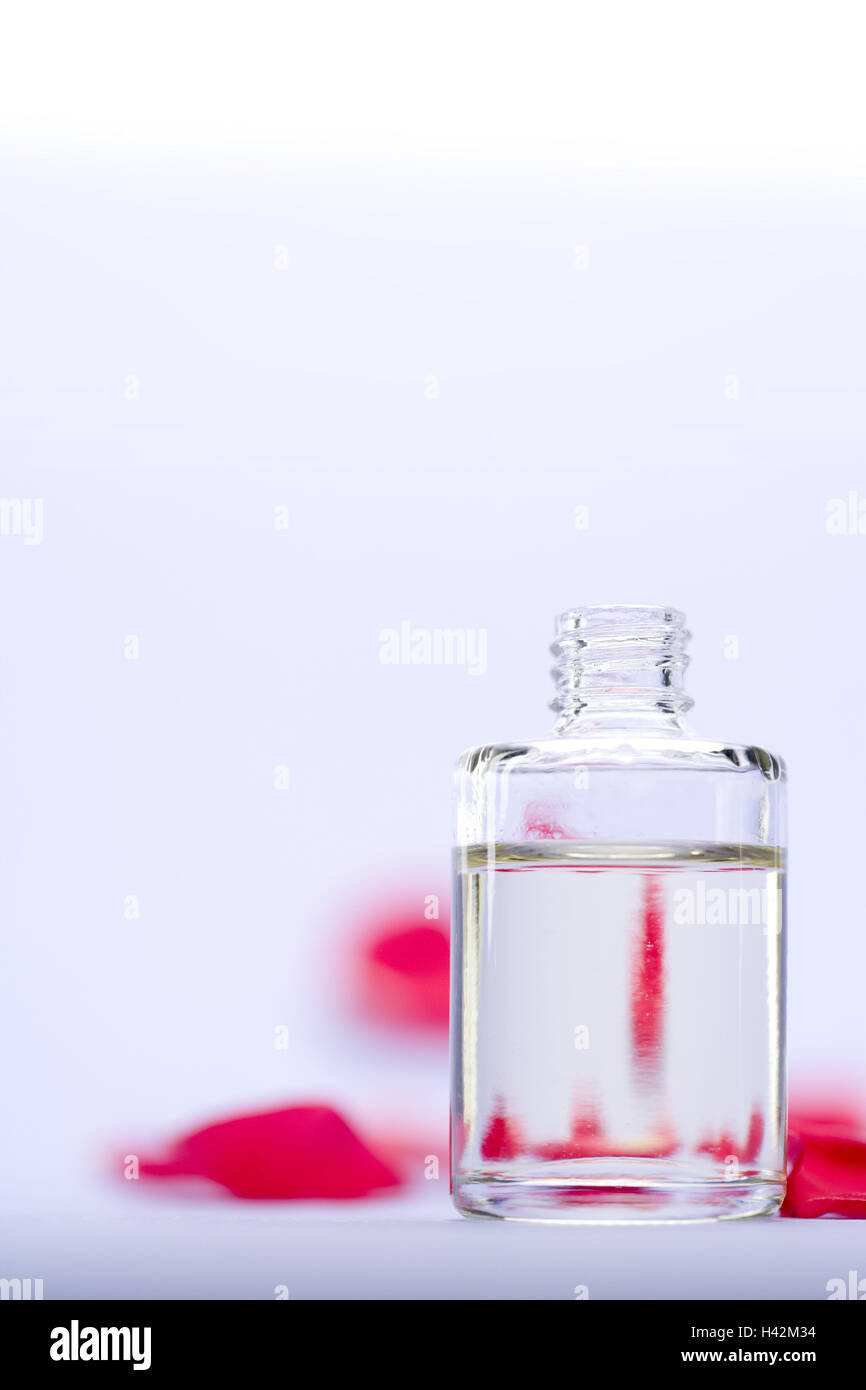 perfume flacon, opened, rose leaves, background blur, Stock Photo