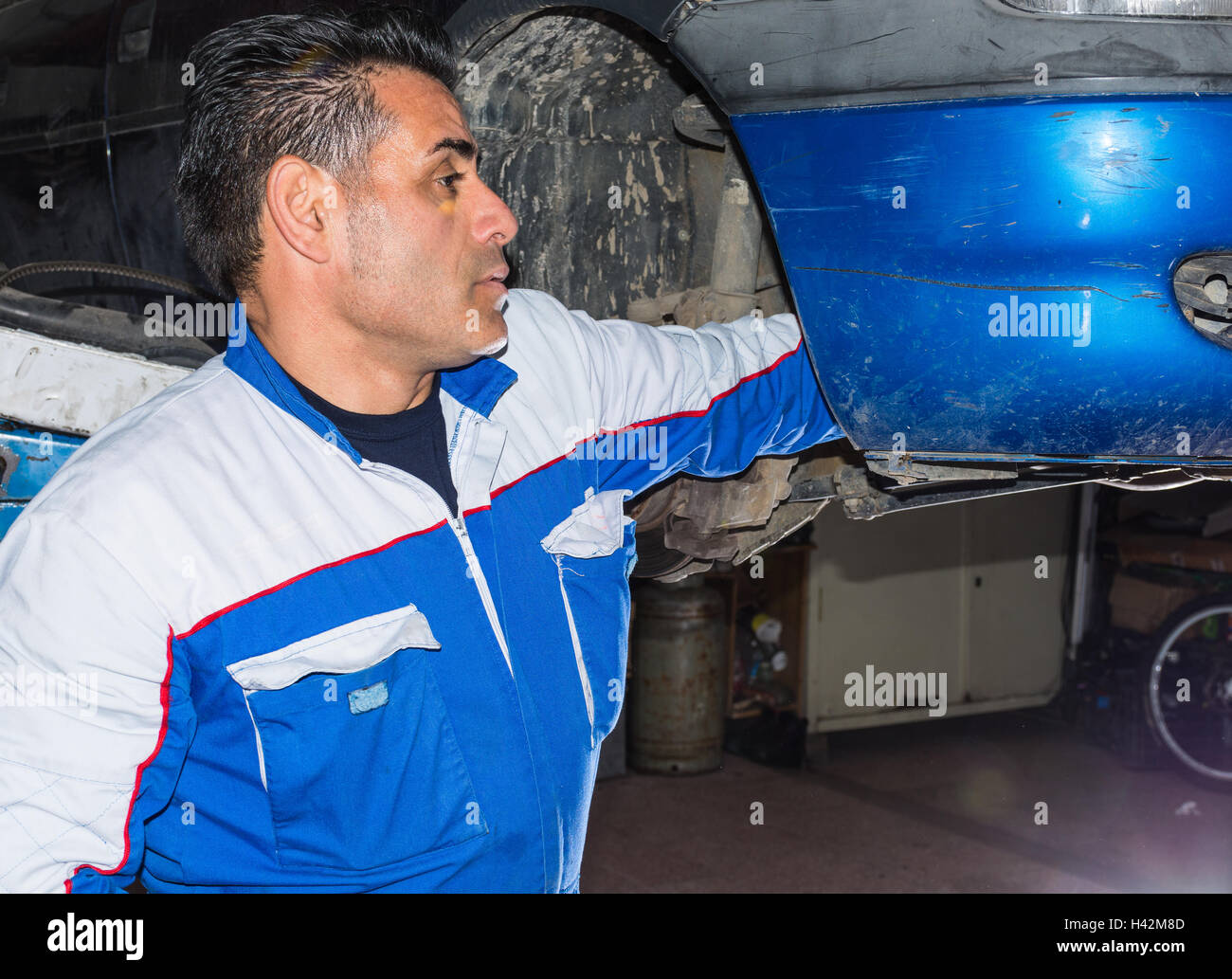 Car mechanic fixing an engine in his garage. copy space. Stock Photo