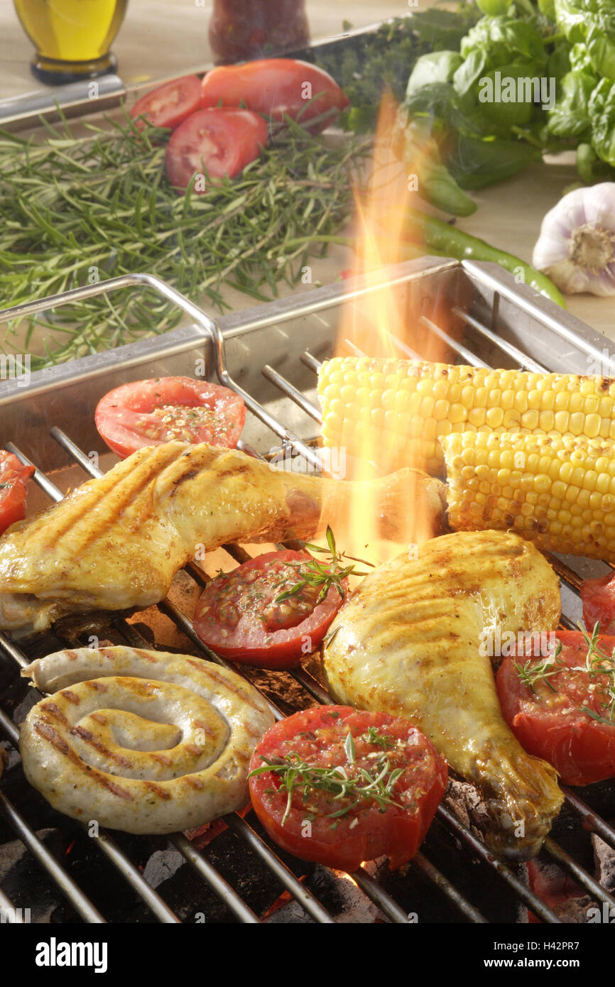 Grill, tongue of flame, chicken legs, corncobs, tomatoes, sausage, Stock Photo