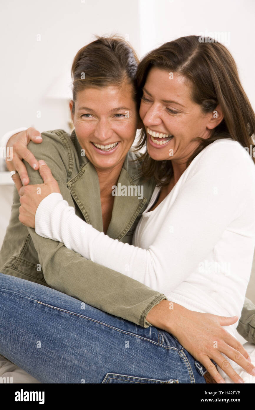 Women, cheerfully, embrace, omitted laughs, semi-portrait, people, 40-50 years, siblings, sisters, friends, two, sits, happily, jokes, joy, fun, enthusiasm, enjoyments, friendship, proximity, cordiality, affection, trust, mutuality, solidarity, harmony, m Stock Photo