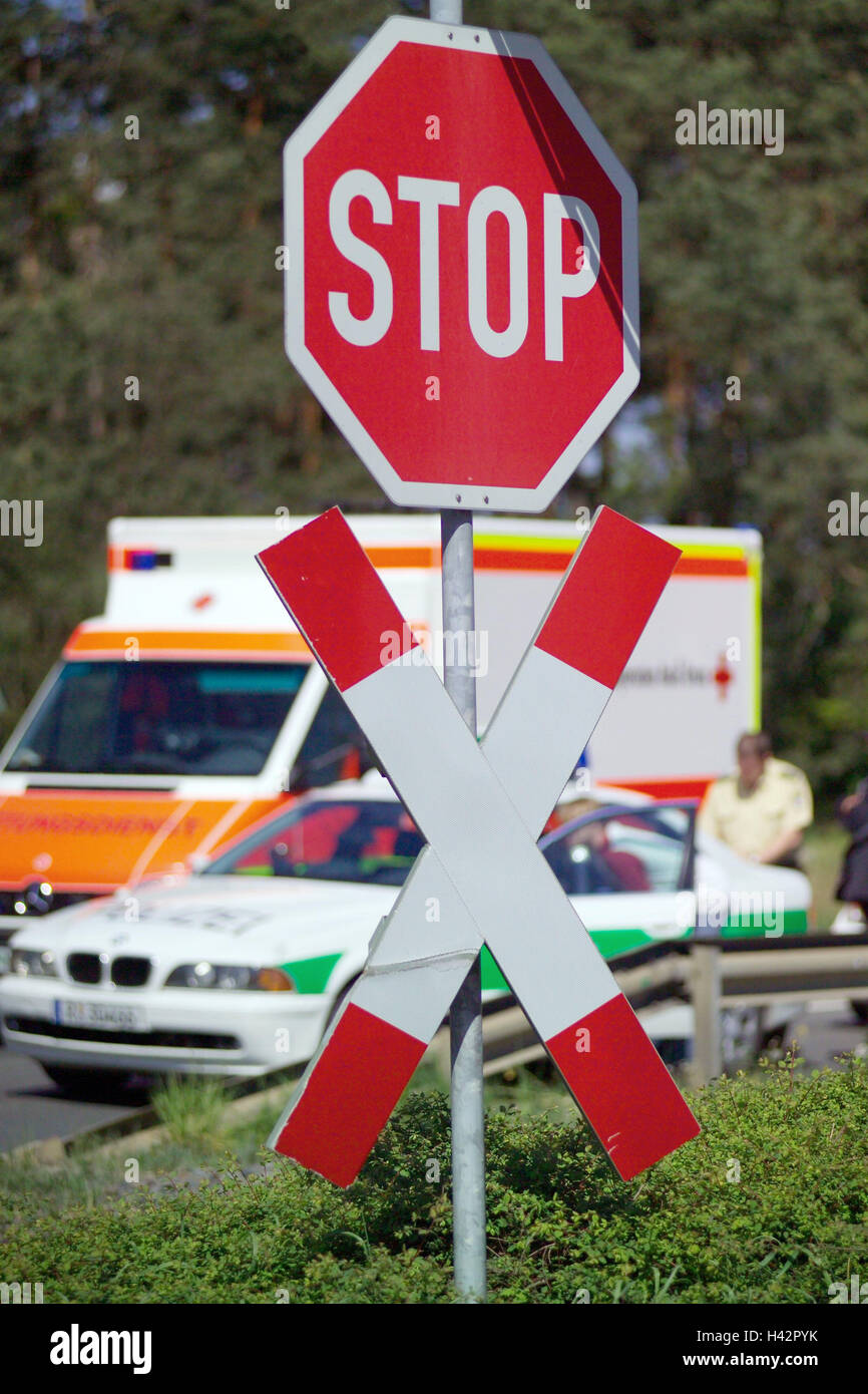Traffic,transport,accident,rescue,street,stop sign,country road,death,road casualty,Road casualty,misfortune,tragically,vehicles,car,police car,rescue car,traffic sign,stop sign,extra bus,policeman,damage,traffic,injury,outpatients,emergency,traffic accid Stock Photo