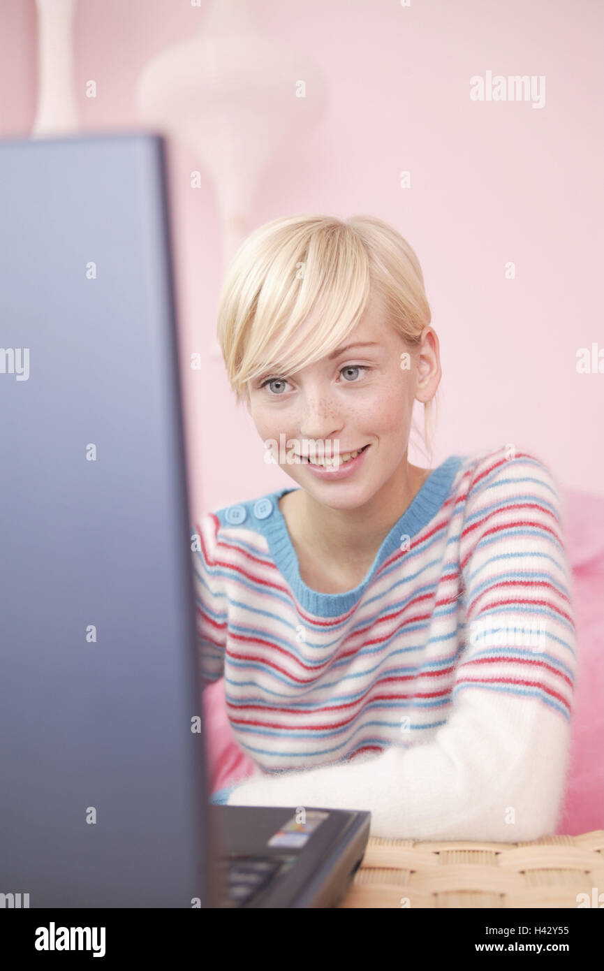 Young persons, blond, notebook computer, data processing, Internet surfing, smile, chat, happy, 16 - 20 years, woman, young, laptop, computer, data entry, interest, attention, information, telecommunication, communication, amusement, fun, leisure time, holidays, privately, at home, inside Stock Photo
