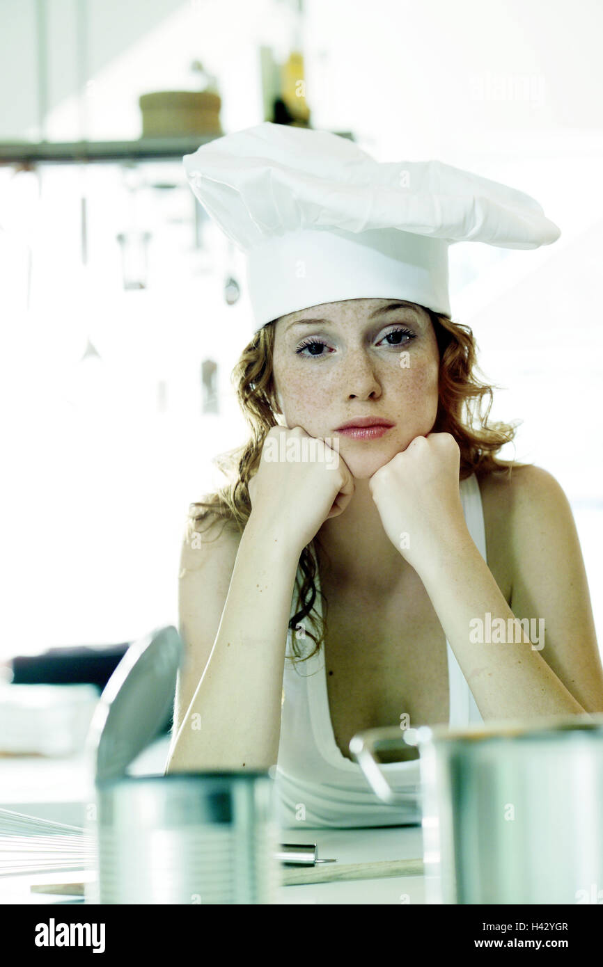 Cook, head rest on, canned food tin, pot, detail, portrait, woman, young, cooking cap, headgear, long-haired, red-haired, curls, cooking, canned food, tin, ready-to-serve meal, leisure time, food, eat, preparation, single, wait, half-heartedly, unsuspectingly, bored, expression, dissatisfied, tiredly, cuisine Stock Photo