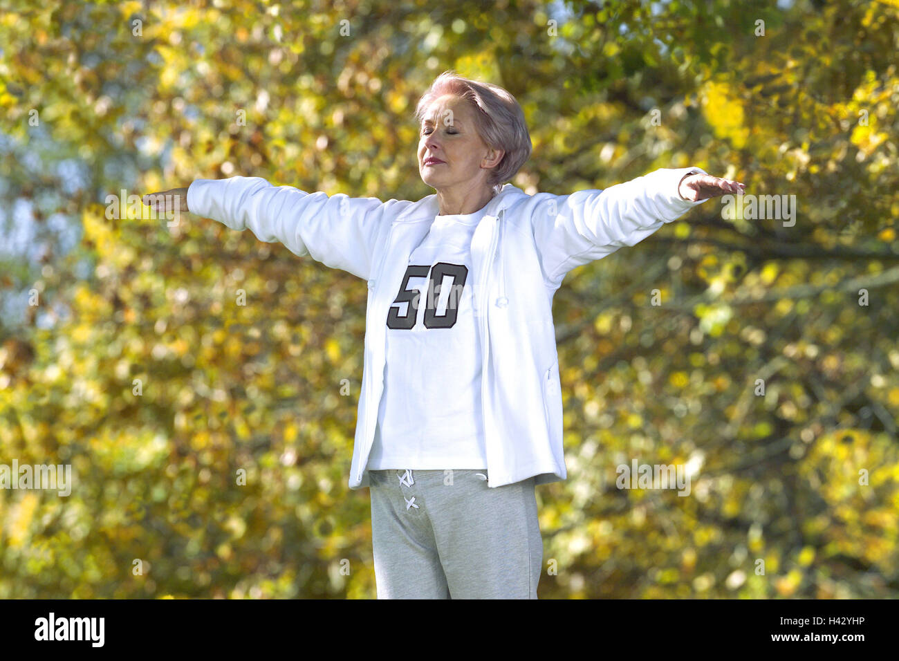 Park, senior, gymnastics exercises, detail, autumn, 55-65 years, woman, Best Agers, gymnastics, gymnastic, motion, arms stretch, eyes closed, recreation, rest, concentration, sportily, sport, fitness, health, activity, conscious body, conscious health, sp Stock Photo